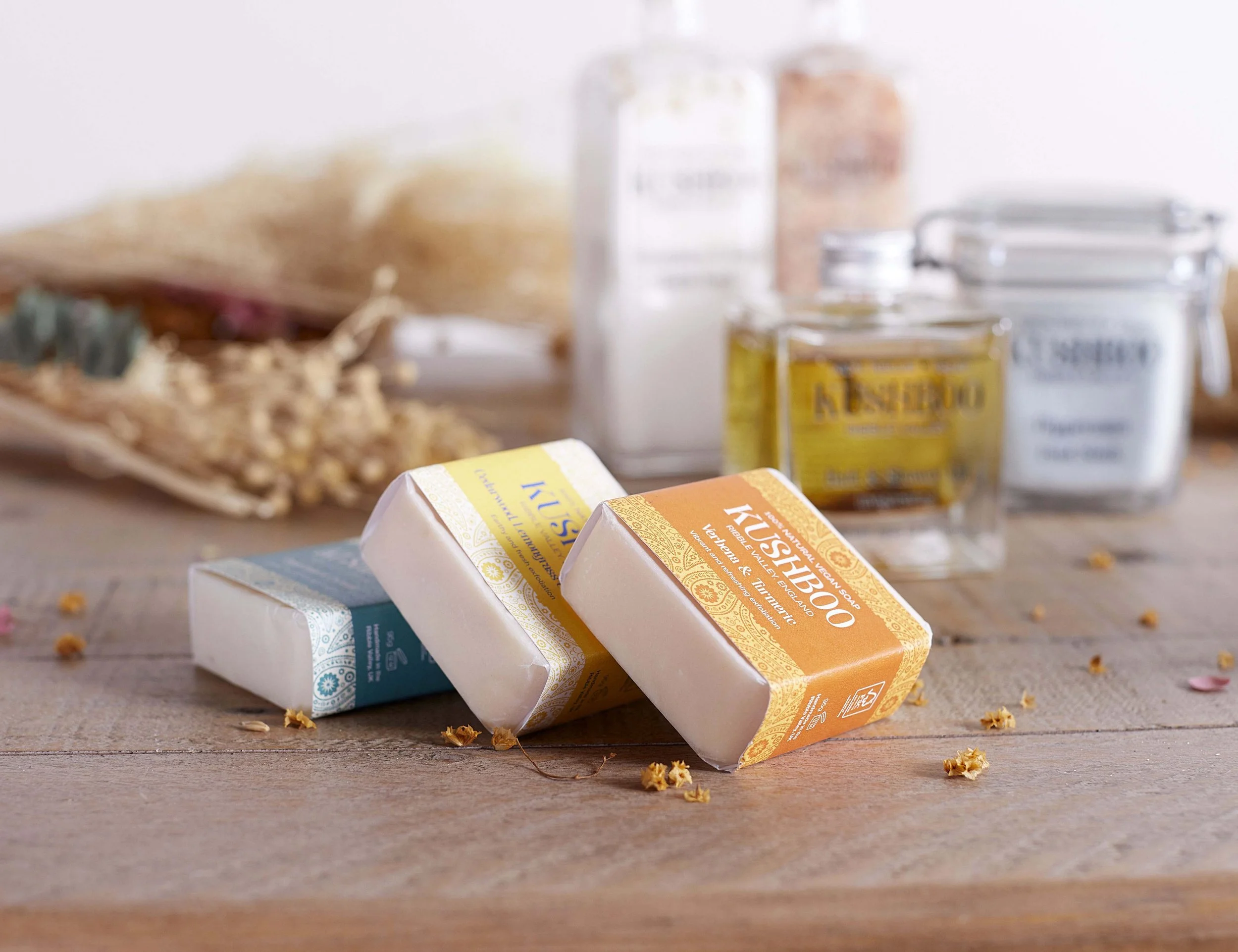 Kushboo bath oil, bath salt and soap still life advisement photography, products with dried flowers photographed in a studio with studio lighting by Victoria Cook photography 