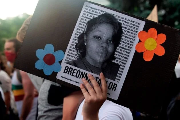 A demonstrator holds up the image of Breonna Taylor, a Black woman who was fatally shot by Louisville police officers, during a protest in Denver on June 3.Jason Connolly/AFP via Getty Images