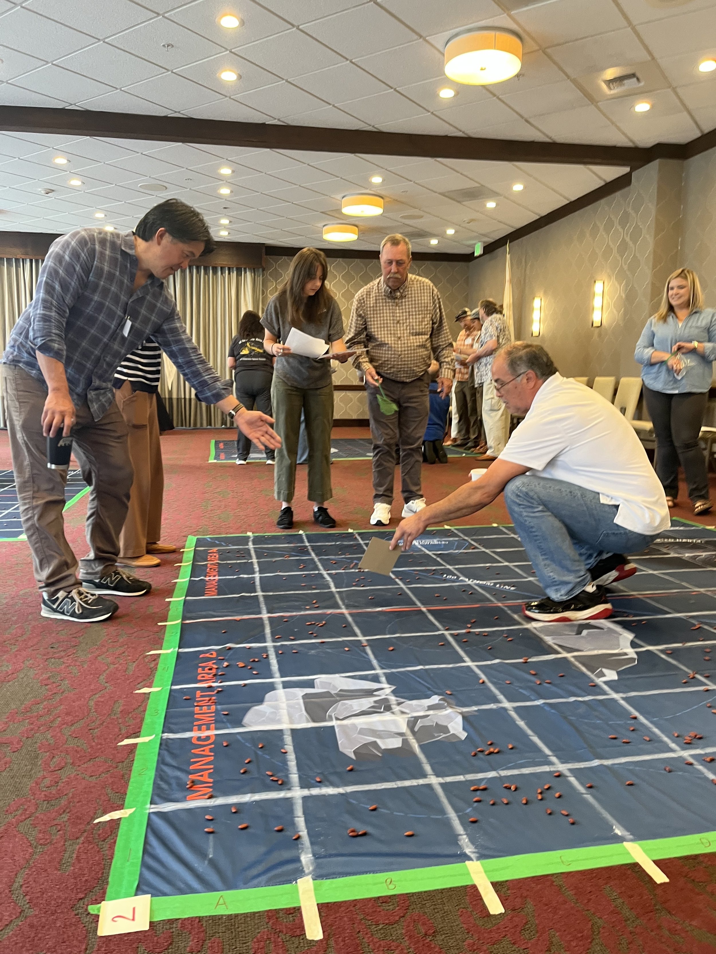 Conference attendees are involved in a hands-on activity simulating surveying fish in the ocean