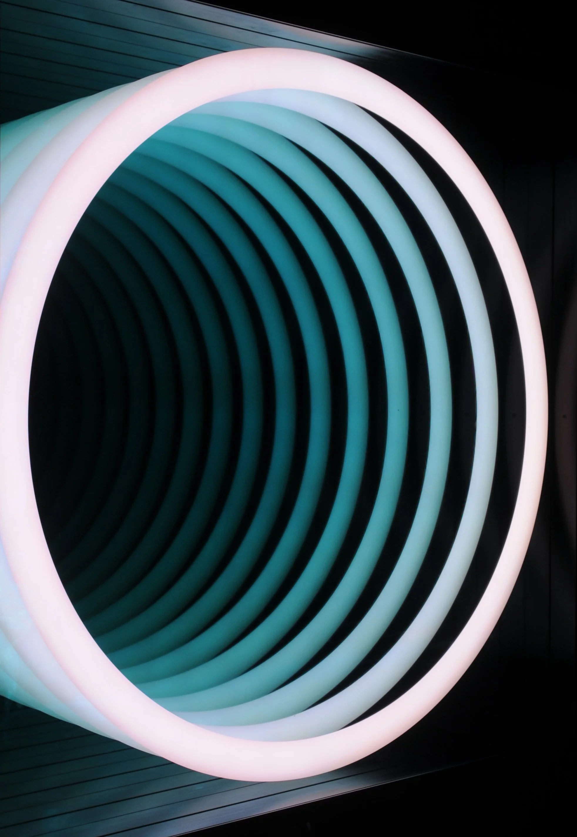 A detail image of Chul Hyun Ahn’s 2020 work, 'Portal', shown from the side. The work consists of plywood, changing LED lights, and mirrors. The image shows a variation of the work’s light display.