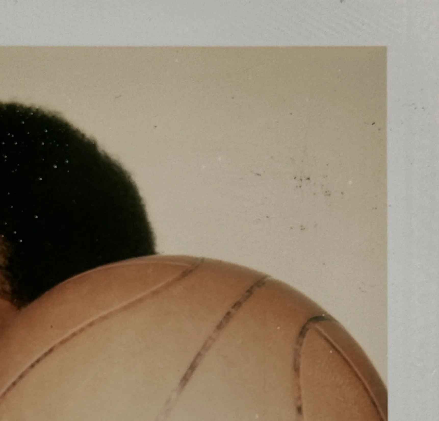 An upper right detail image of Andy Warhol’s unique Polaroid print, 'Kareem', shown here unframed.