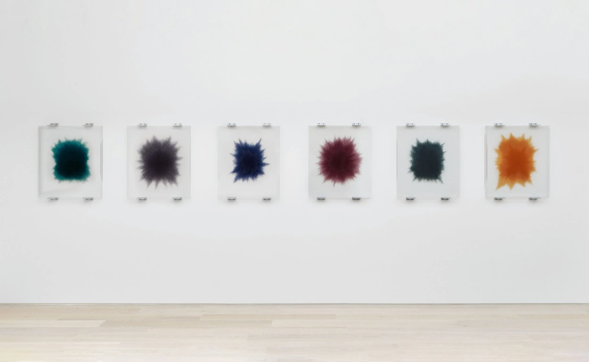 Idris Khan’s suite of six wall-mounted reliefs, 'After the setting sun'. From left to right, pictured are azure blue, paynes grey, indigo, deep crimson, pine green, and french sienna. Image courtesy of Cristea Roberts Gallery, London..
