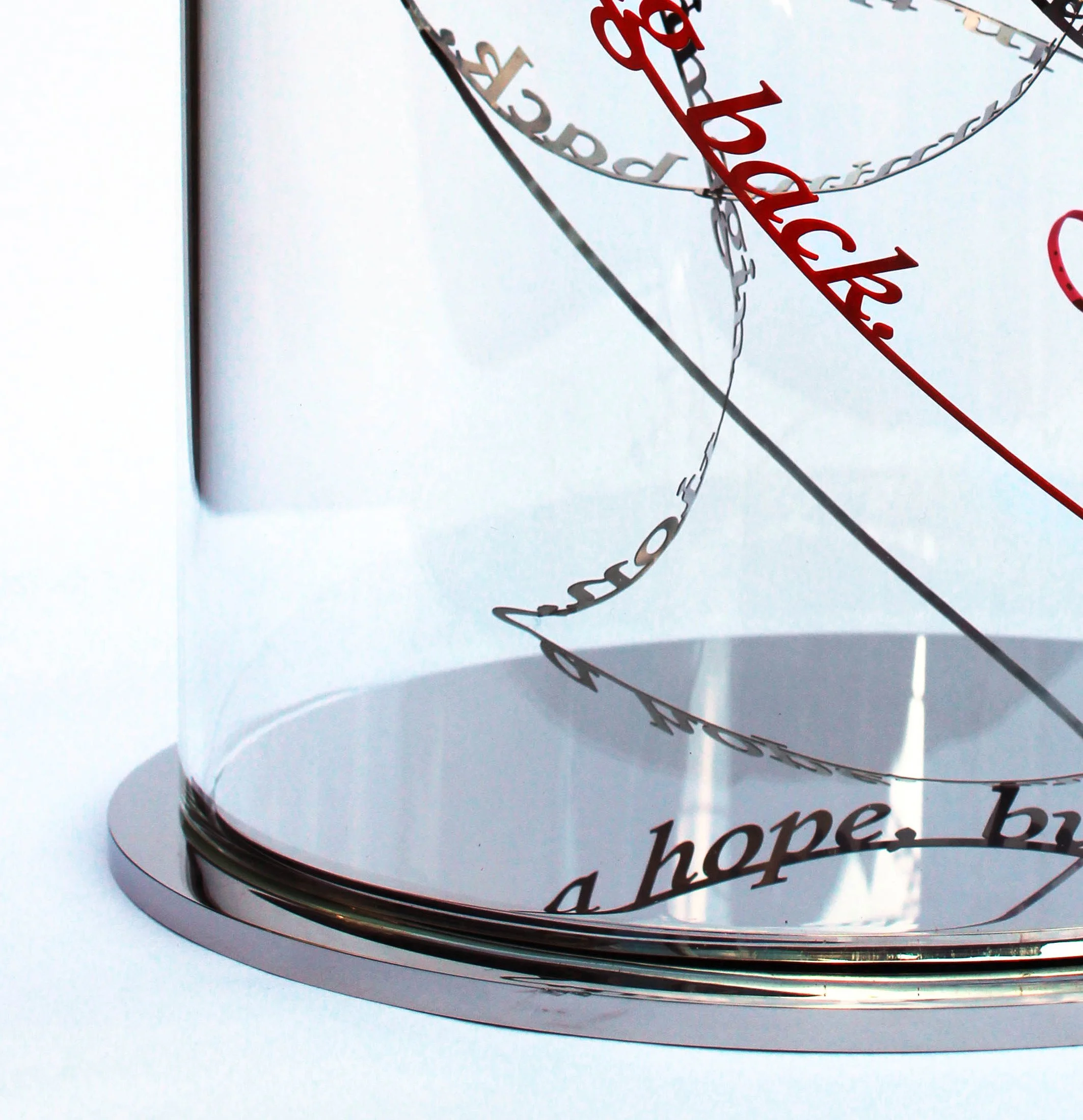 A detail from Nicola Anthony’s 'Unexpected Happiness (In this moment you see the rainbow)', a stainless steel sculpture on a mirrored base; in a hand-blown glass dome.