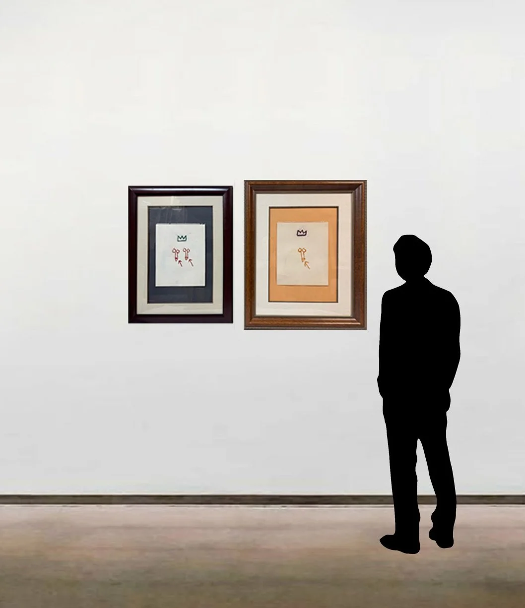 Two drawings with oil stick by Jean-Michel Basquiat, shown framed and scaled alongside a six foot figure.