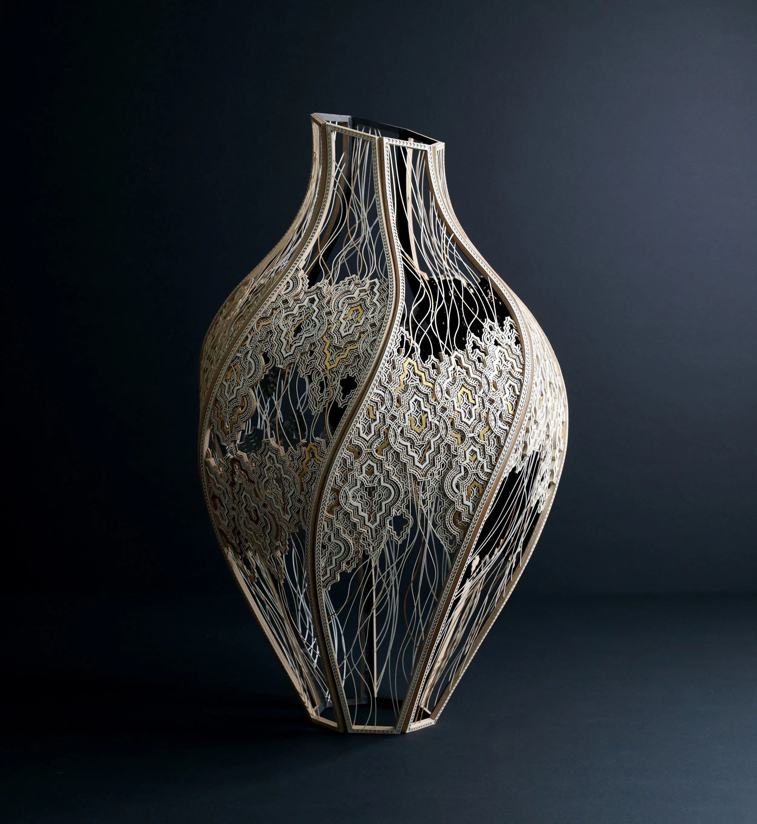 A full vertical image of Julia Ibbini’s 'Kŷma | Vessel'. The work is comprised of paper, ink, cotton, and gold leaf.