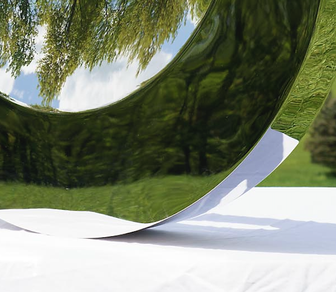 A detail image of Tarik Currimbhoy’s 316 Stainless steel kinetic work, The Eye. The sculpture is shown at its base, resting on a white pedestal.