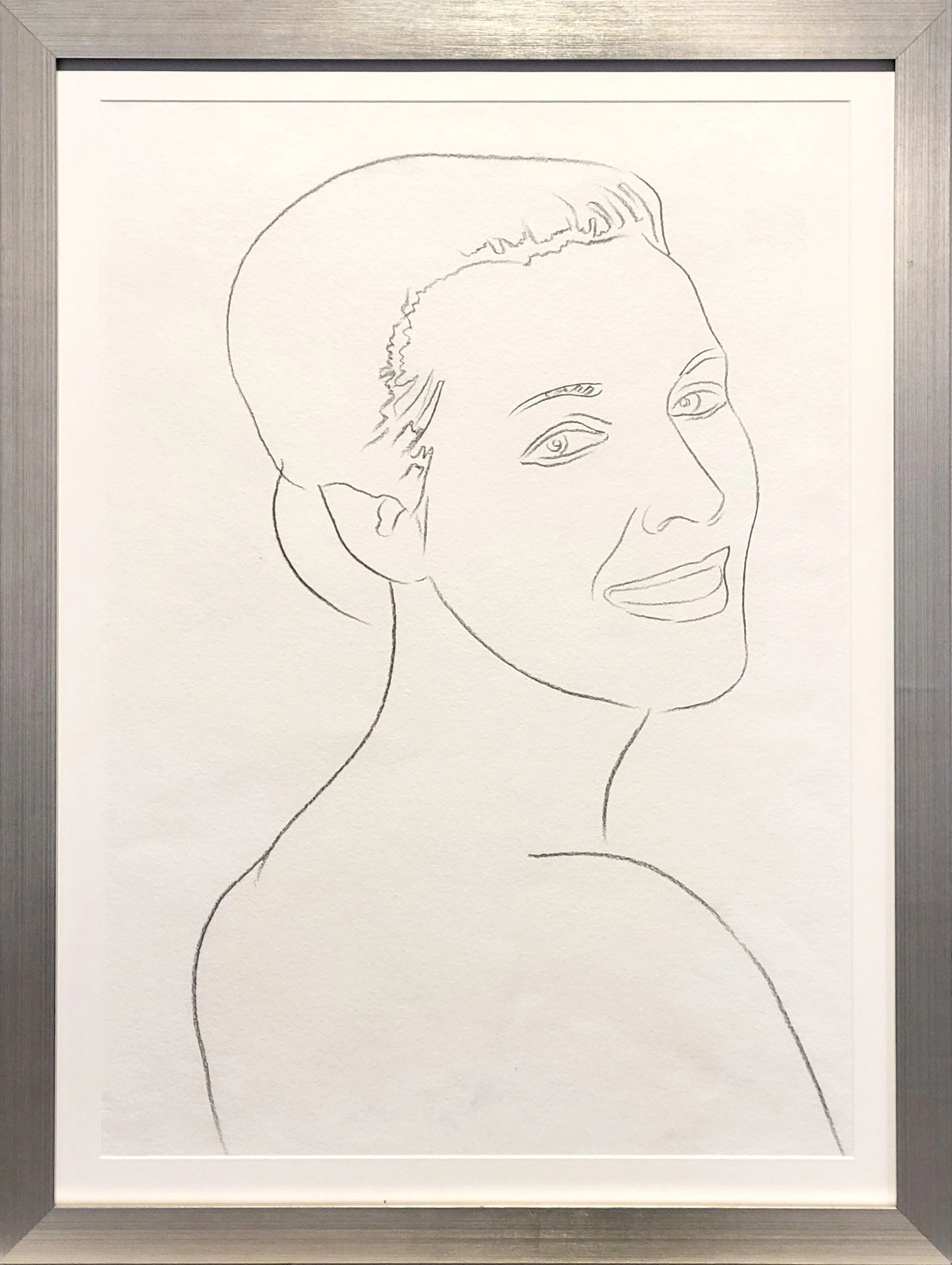 Andy Warhol’s unique graphite drawing on paper, 'Female Portrait', shown here in a metallic frame.