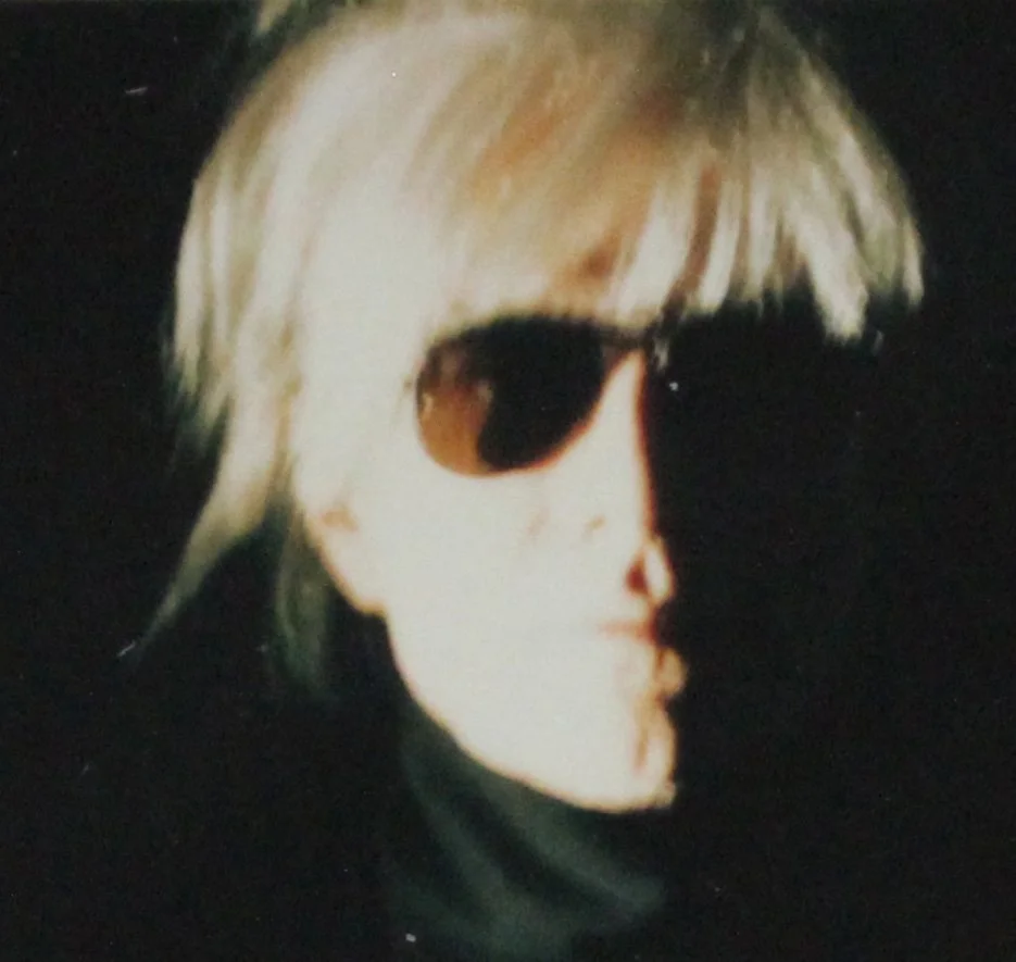 A detail close-up of Andy Warhol’s unique Polaroid print, 'Self-Portrait in Fright Wig', shown here unframed.