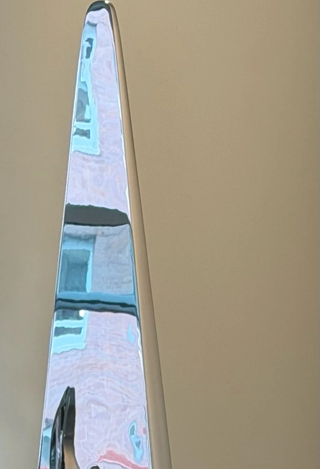 A detail image of Propeller by Tarik Currimbhoy, an L316 Marine-grade stainless steel kinetic sculpture. The upper spire portion is shown here.