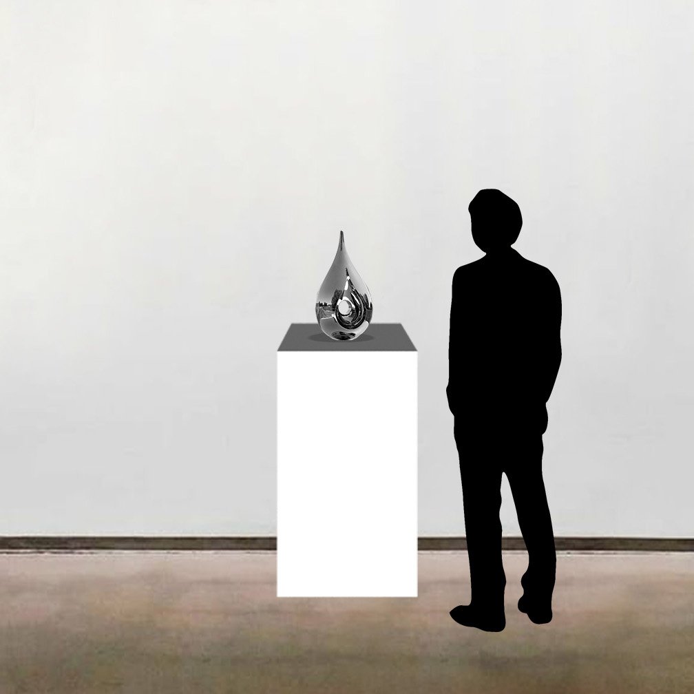 A to-scale image of Tarik Currimbhoy’s kinetic stainless steel sculpture, 'Paisley', shown on a pedestal alongside a six foot tall figure.