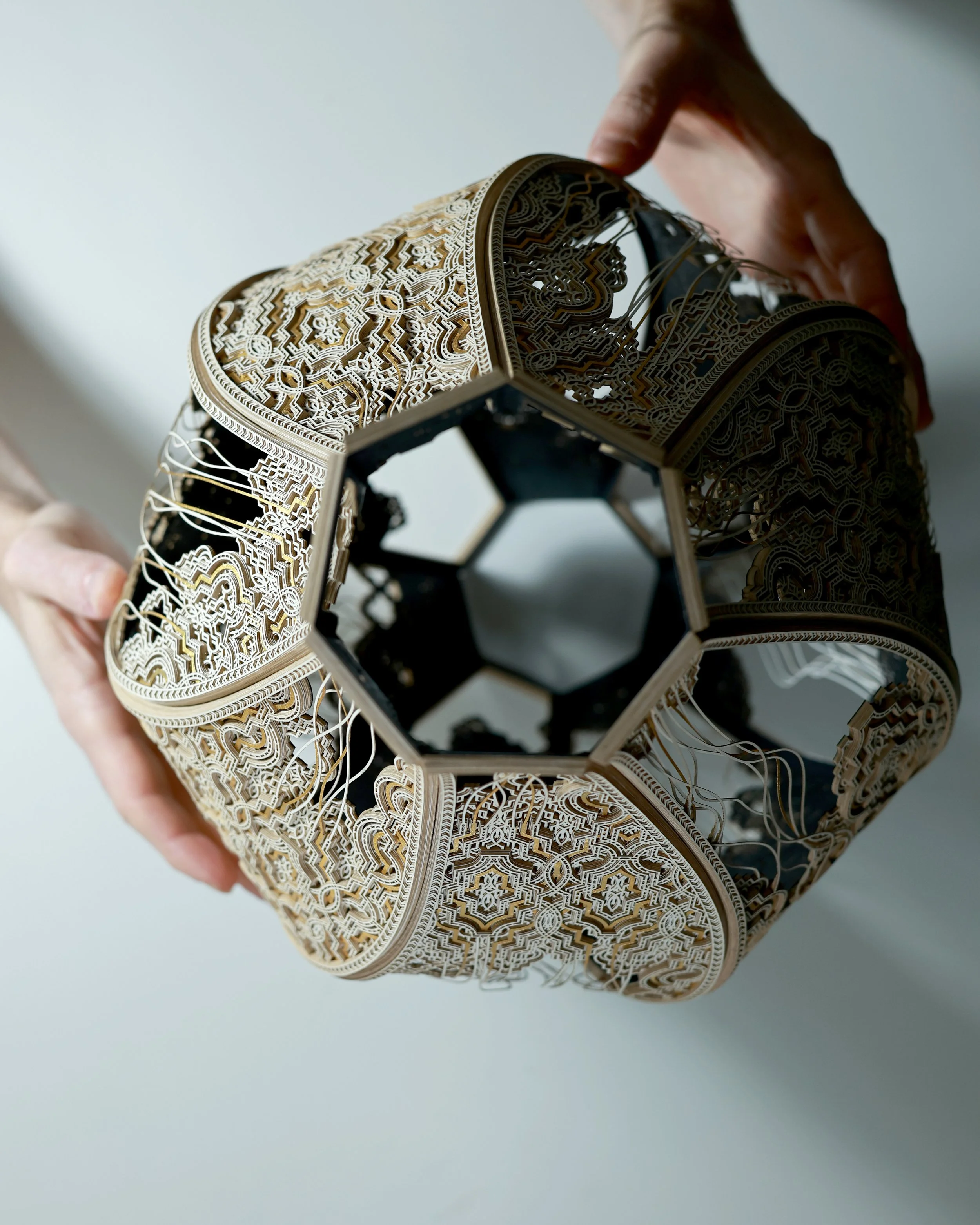 An overhead image of Julia Ibbini’s 'Kŷma | Vessel'. The work is comprised of paper, ink, cotton, and gold leaf.