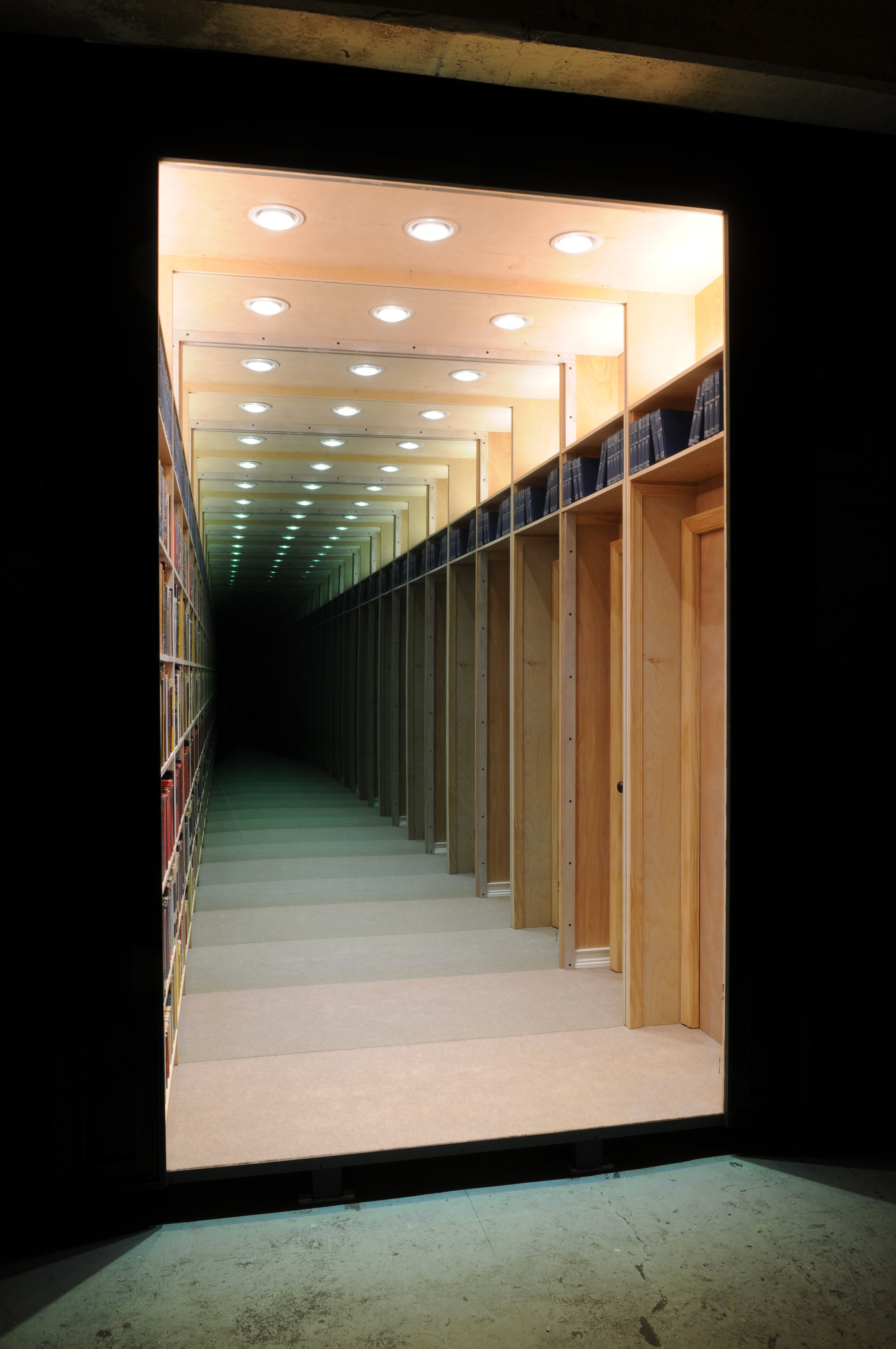 An alternate angle of Chul Hyun Ahn’s 2018 work, ‘Library’. The work consists of wood, aluminum, LED lights, books and mirrors.