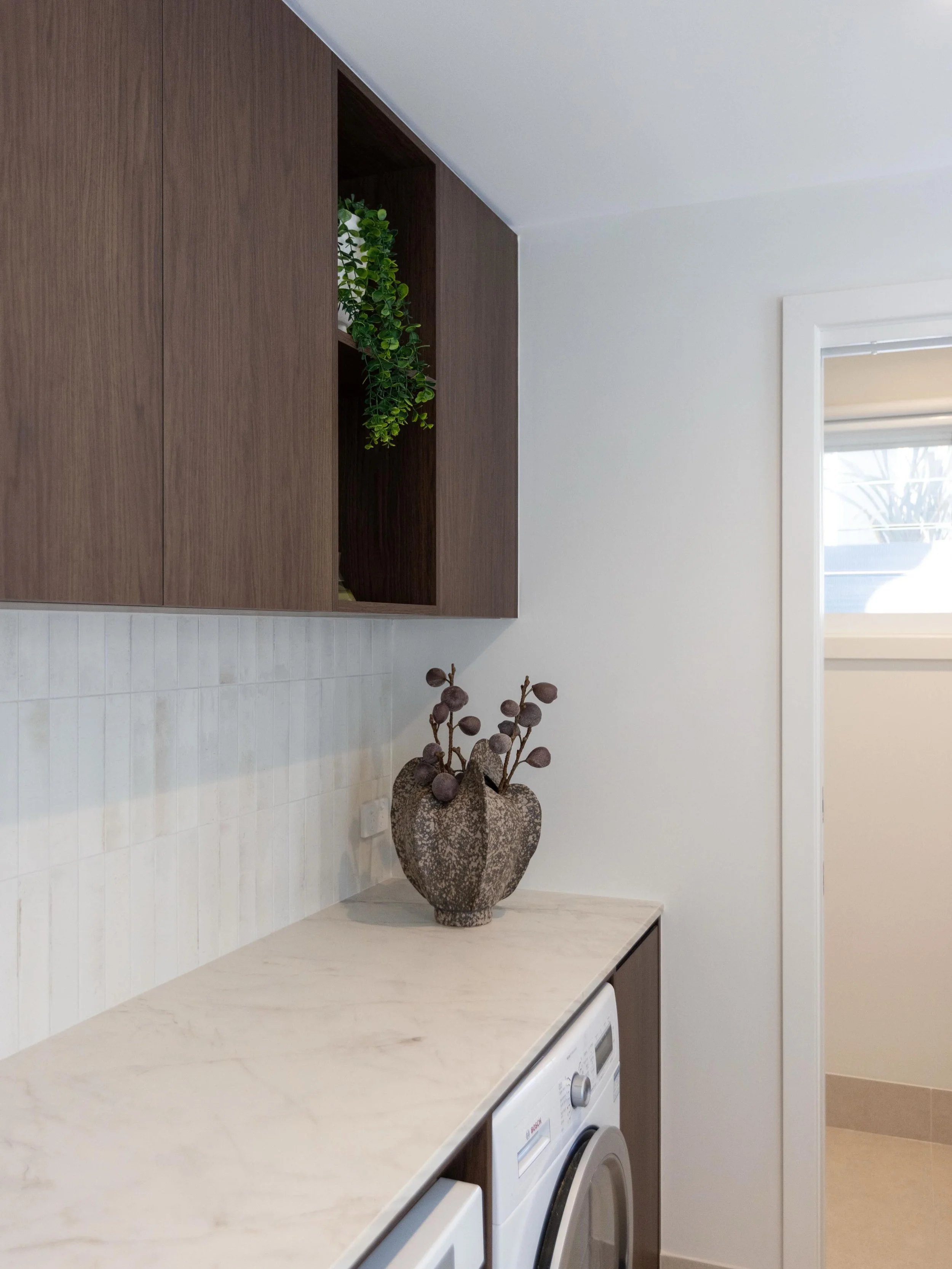 NORTH WOLLONGONG. Luxurious laundry and powder room design. Elegant and functional, featuring expansive bench tops an oversized fireclay sink, custom joinery and luxe finishes. 

Interior Design @_cs_interiors_ 
Builder @connorbathrooms 
Photograpy @