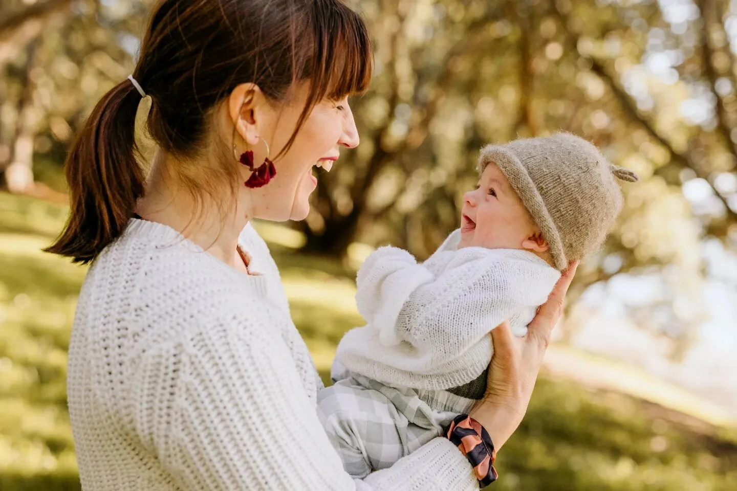 As a family photographer, I am constantly reminded of the beauty and tenderness that comes with motherhood. This photo captures one of my favourite moments - a beaming mum holding her little one in the midst of nature's wonder. It's these moments tha