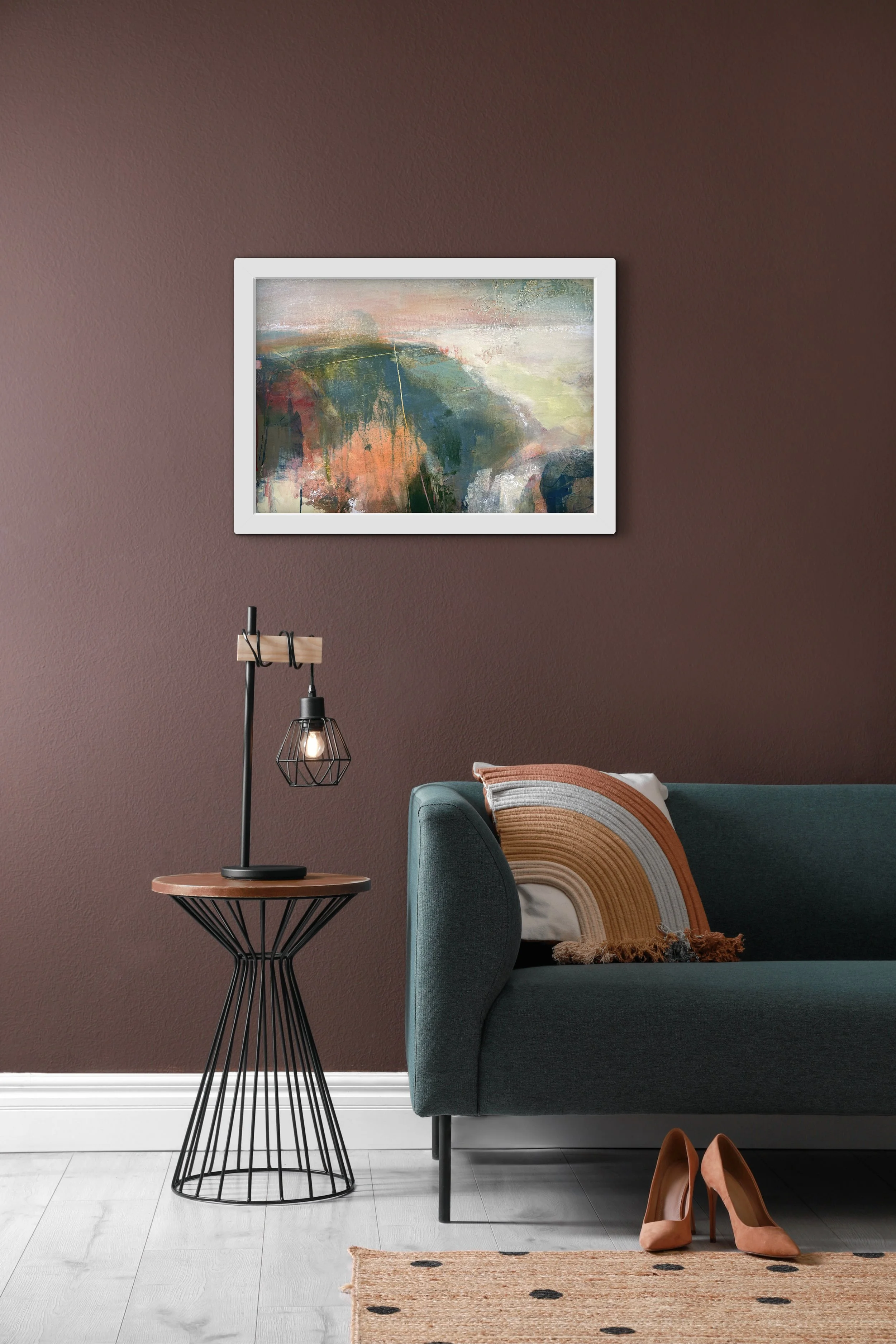 Colourful abstract landscape hung on a burgundy wall