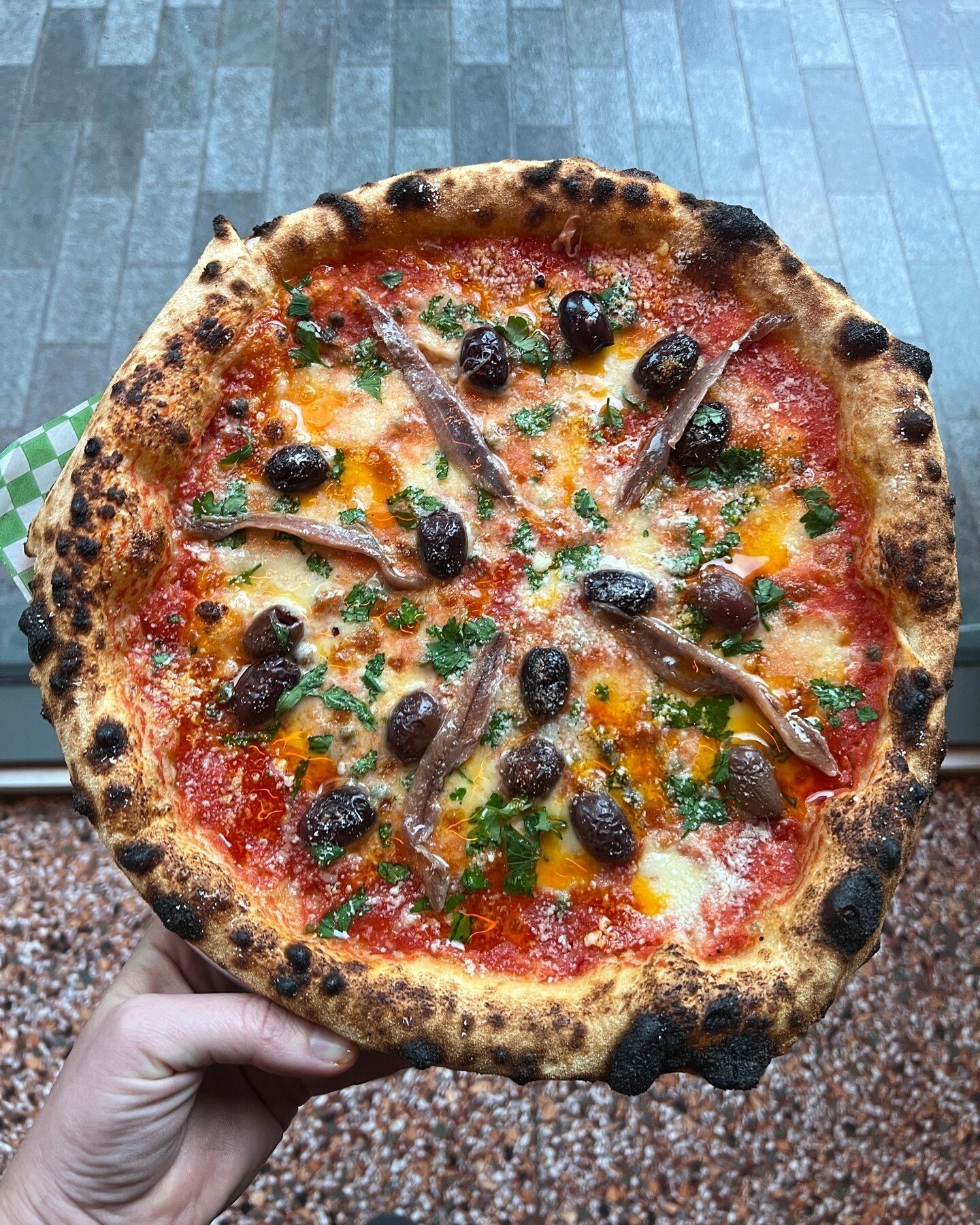 So, we totally don't give enough credit to the Puttanesca, but it's the bomb for getting through the middle of the week. We're talkin' fresh Fior di latte, Kalamata olives, non-pareille capers, anchovies, topped off with some spicy house chilli oil a