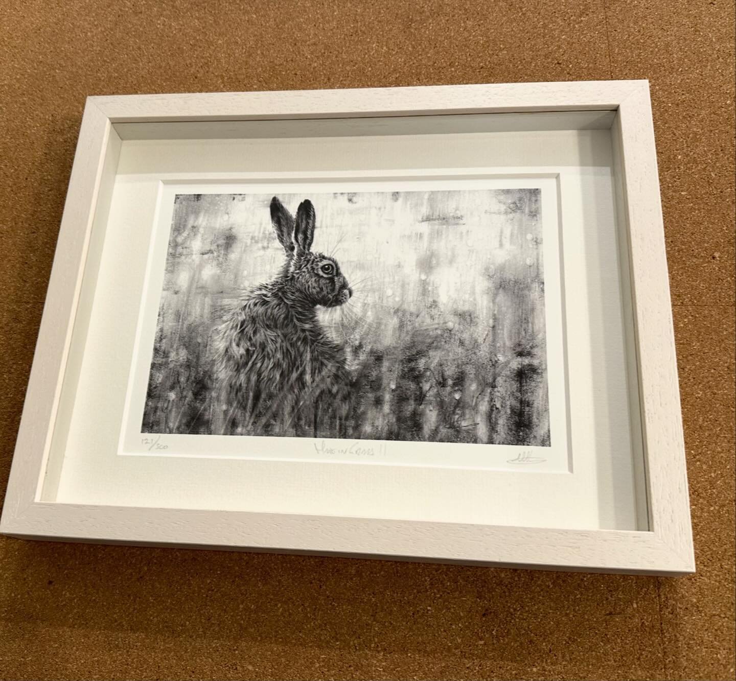 &lsquo;Hare in Grass II&rsquo; limited edition print framed in an off-white moulding, mounted and set back in the frame.