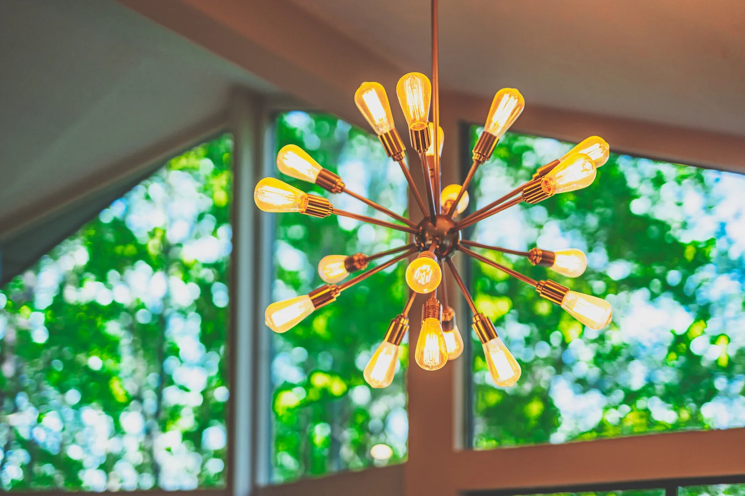 Sputnik chandelier against soft green window light