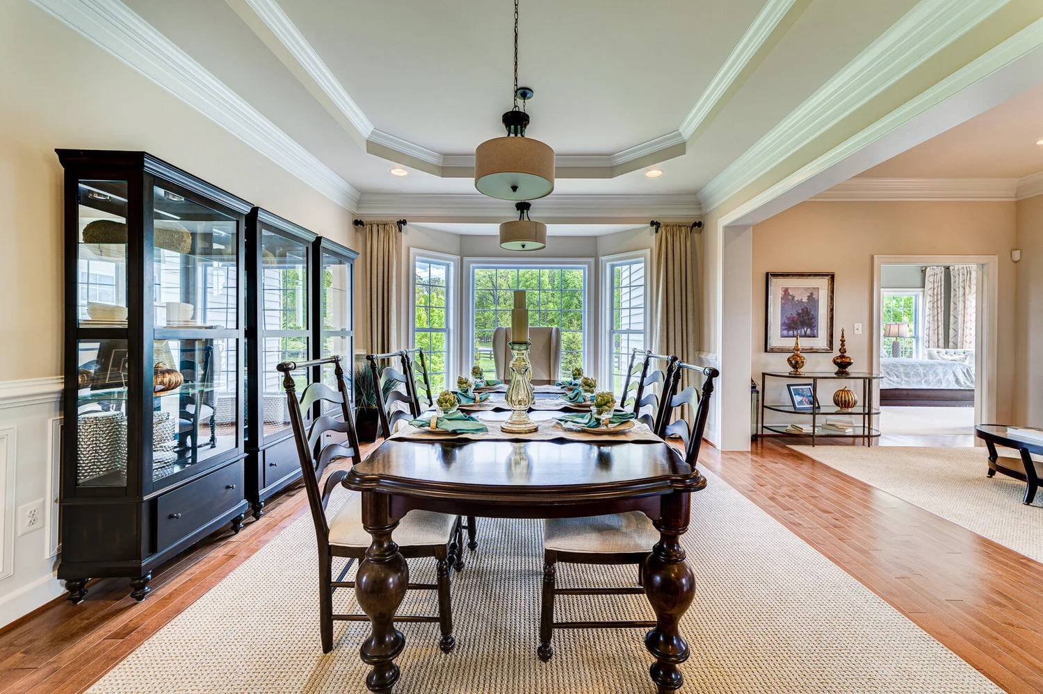 Staged great room with a wall of windows