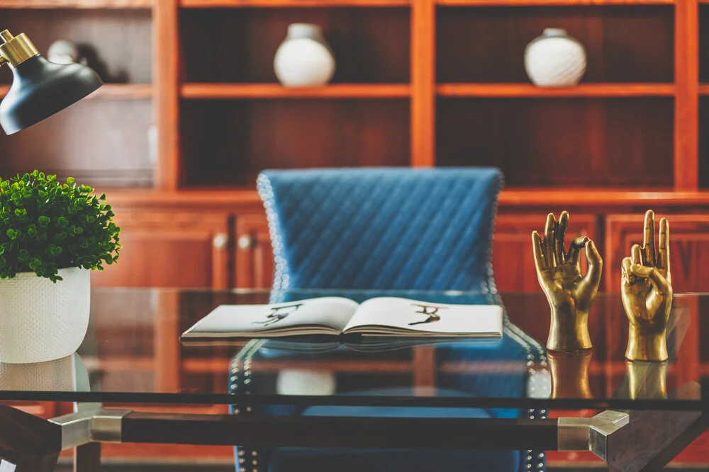 Blue reading chair against a bookshelf, soft focus