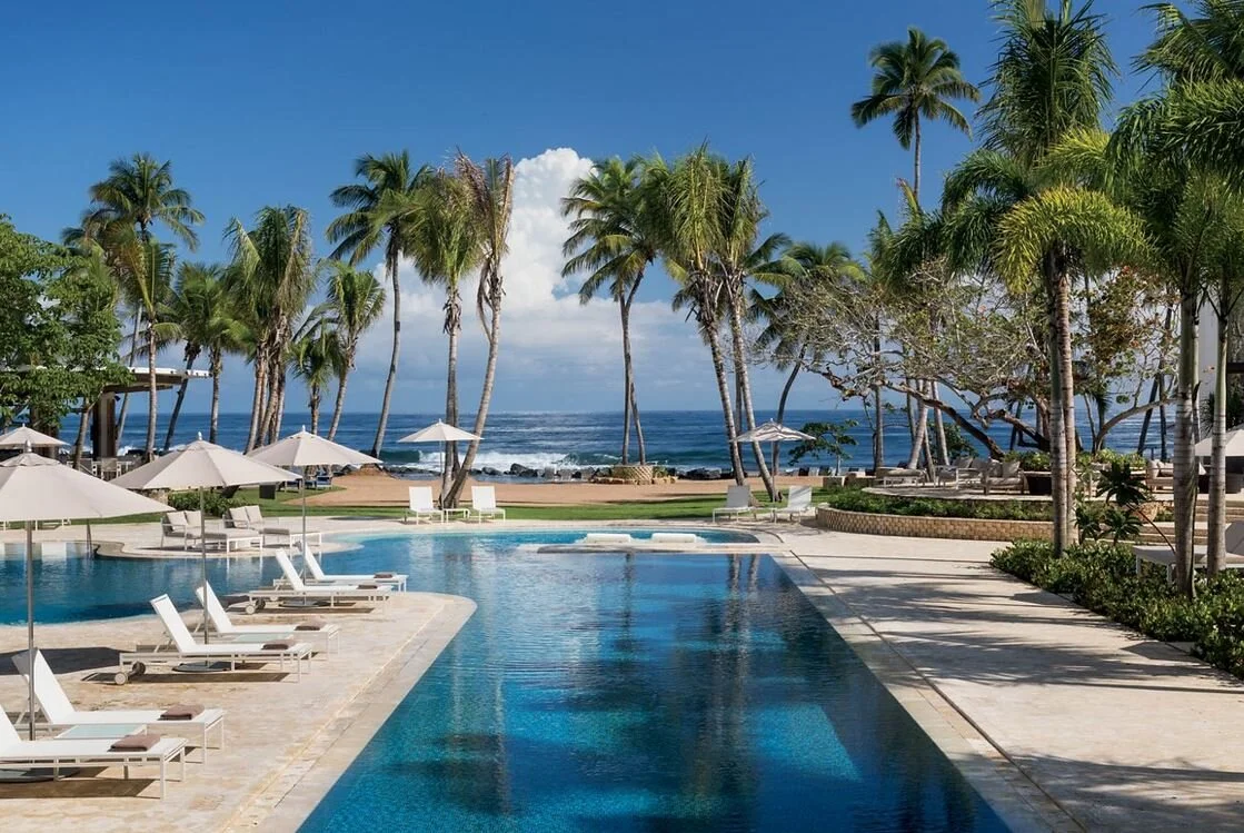 Picture of a pool deck near the ocean. Marriott Stars Preferred Partner Ritz Calron Dorado Beach - Huffman Travel.JPG