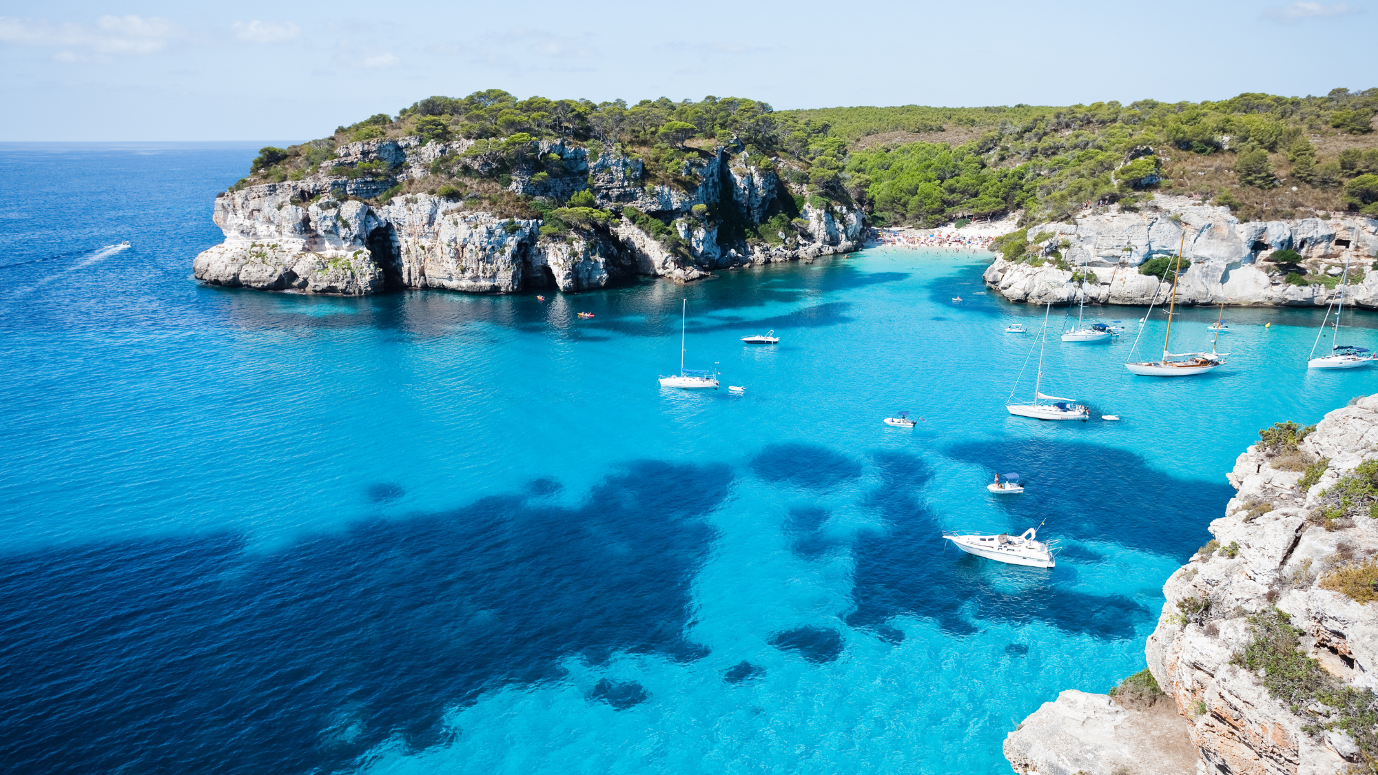 Huffman Travel Image of clear blue water and boats in Menorca