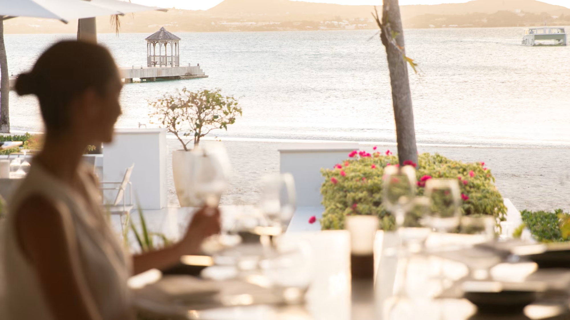 Huffman Travel Hero Photo of Jumby Bay woman dining on waterg