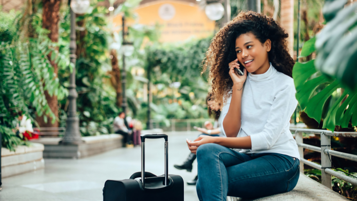 Huffman Travel image of woman on phone asking for Medical Care Abroad by Allianz Partners.png
