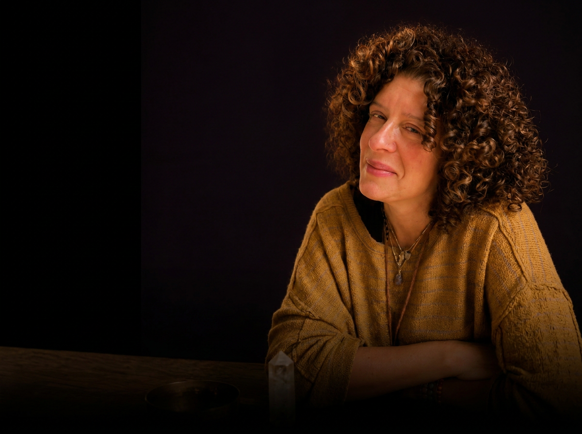Jessica Garet, LCSW, seated beside a candle, crystal, and singing bowl.