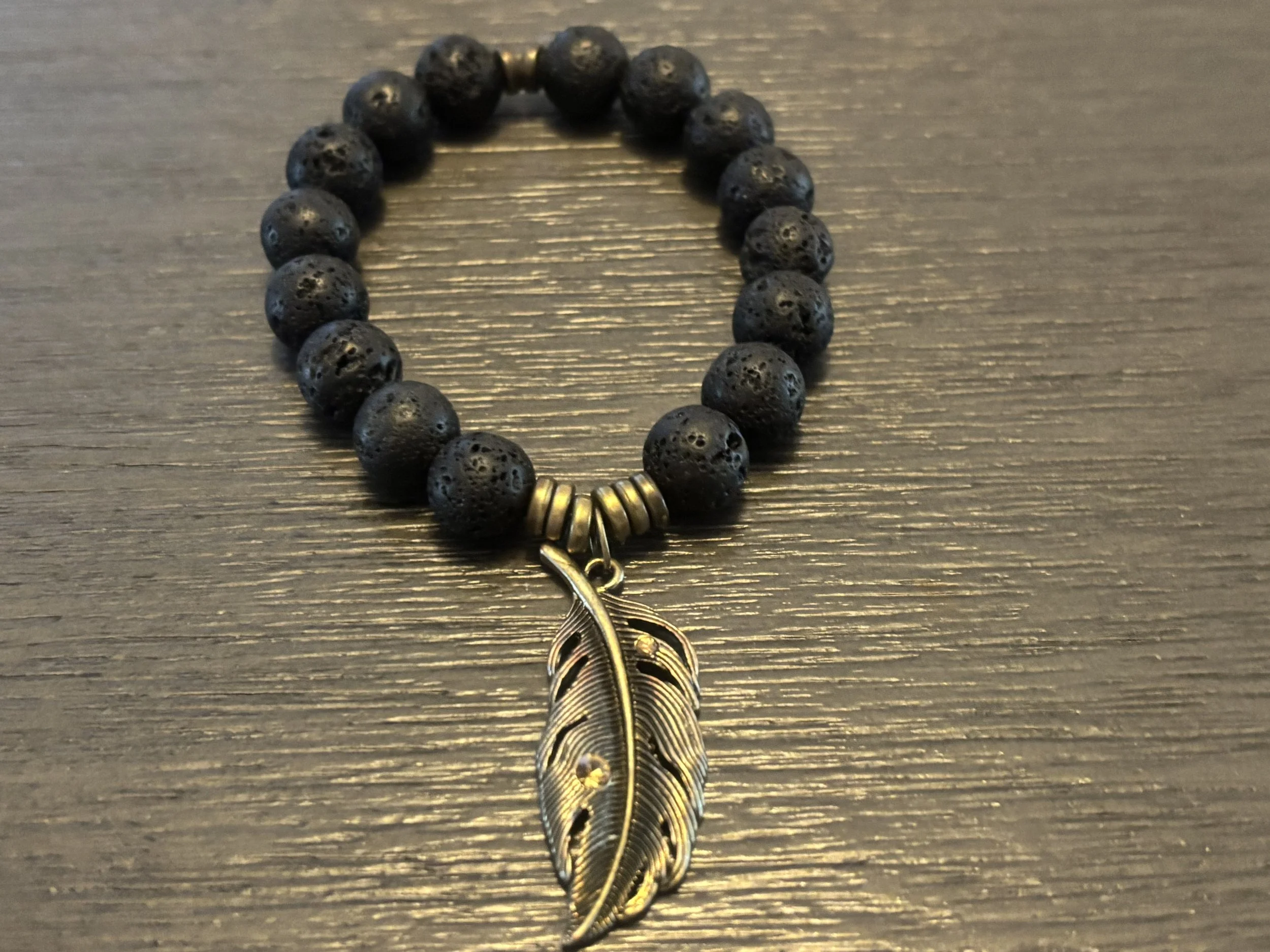 Golden Feather Pendant Black Charcoal Beaded Bracelet