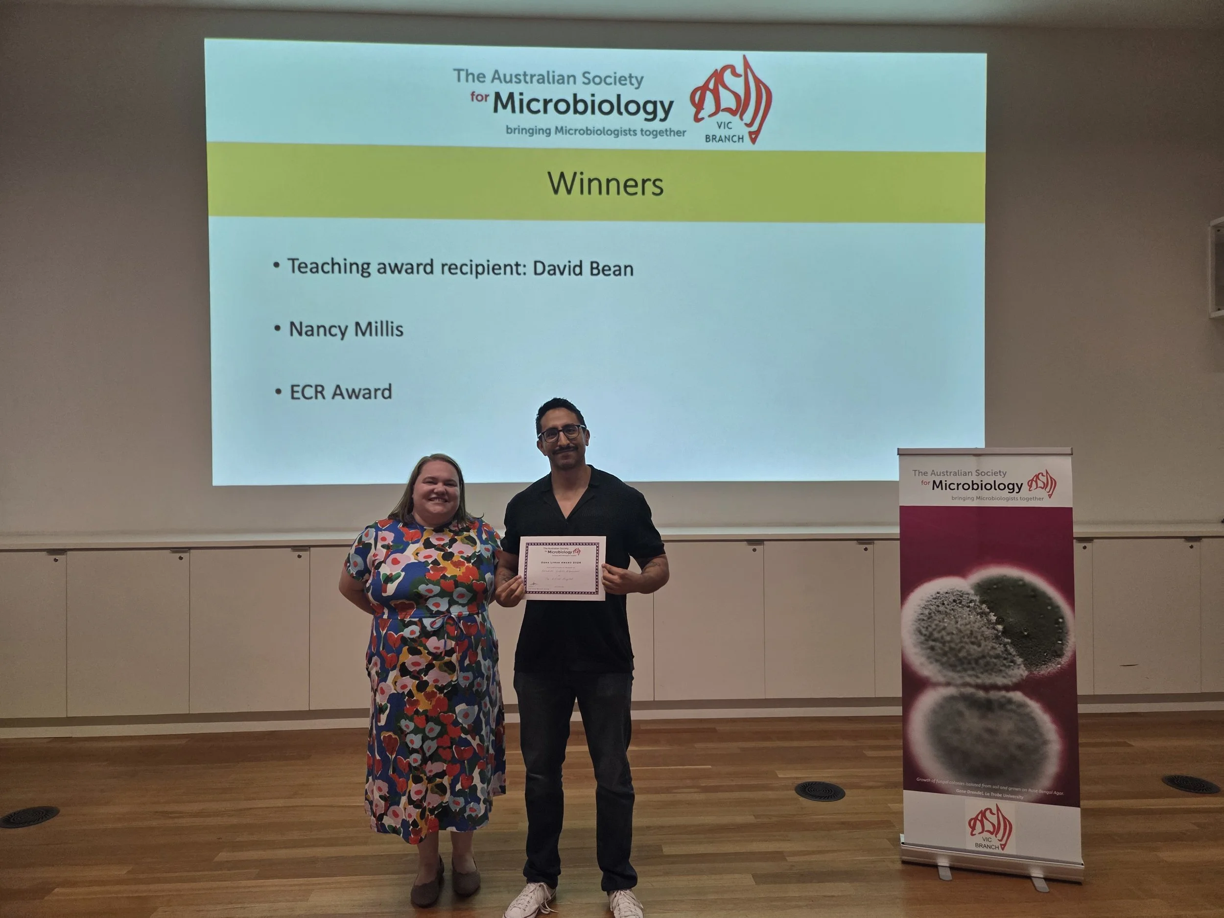 Dena Lyras ECR 2026 Awardee Fernando Gordillo Altamirano  (right) and ASM Vic Branch Deputy Chair Dr Sarah Baines (left)
