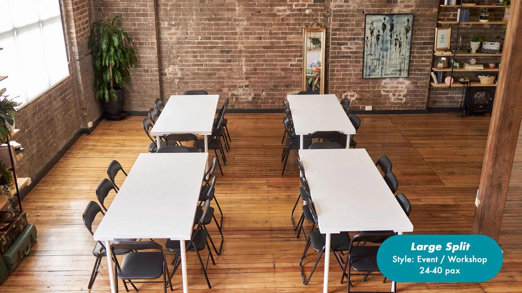 Large event and workshop room with four white tables, black folding chairs, exposed brick walls, wood floors, plants, artwork, and shelving; seats 24–40 people at the Dale Studio in Chippendale. 