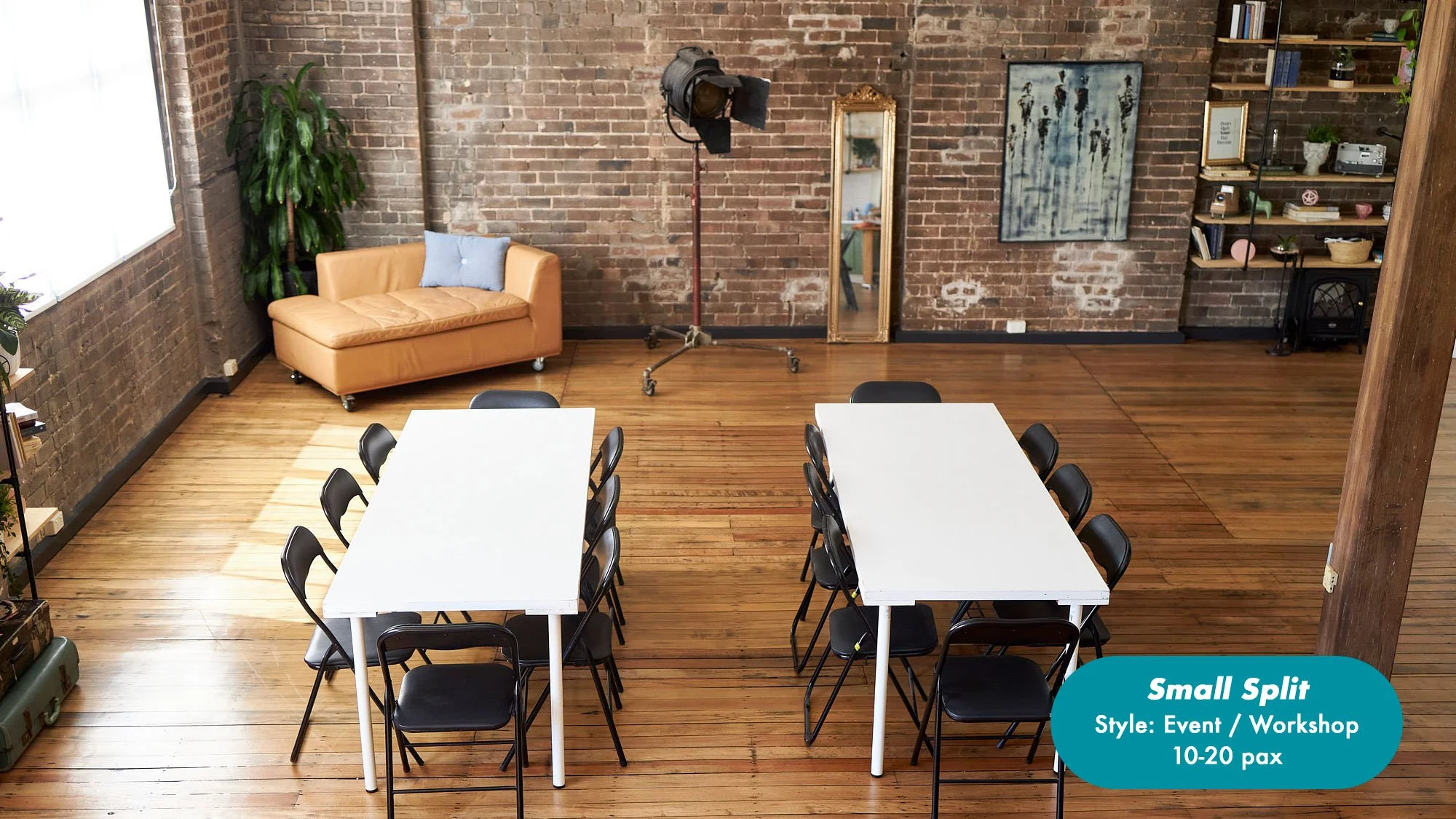 Small event and workshop space with two white tables, black folding chairs, tan sofa, exposed brick walls, hardwood floors, and studio lighting at the Dale Studio in Chippendale. 