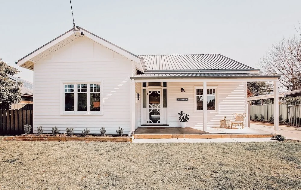 Front porch of the white weatherboard heritage home (*shitshack) that Lisa and Boots purchased