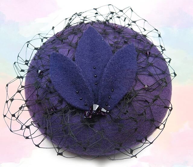 This dotey button shaped fascinator is made of a rich purple felt and is finished with amethyst Swarovski crystals and black netting. #lulandamakes #purple #amethyst #swarovskicrystals #button #hat #fascinator #millinery #milliner #design #pastelaest