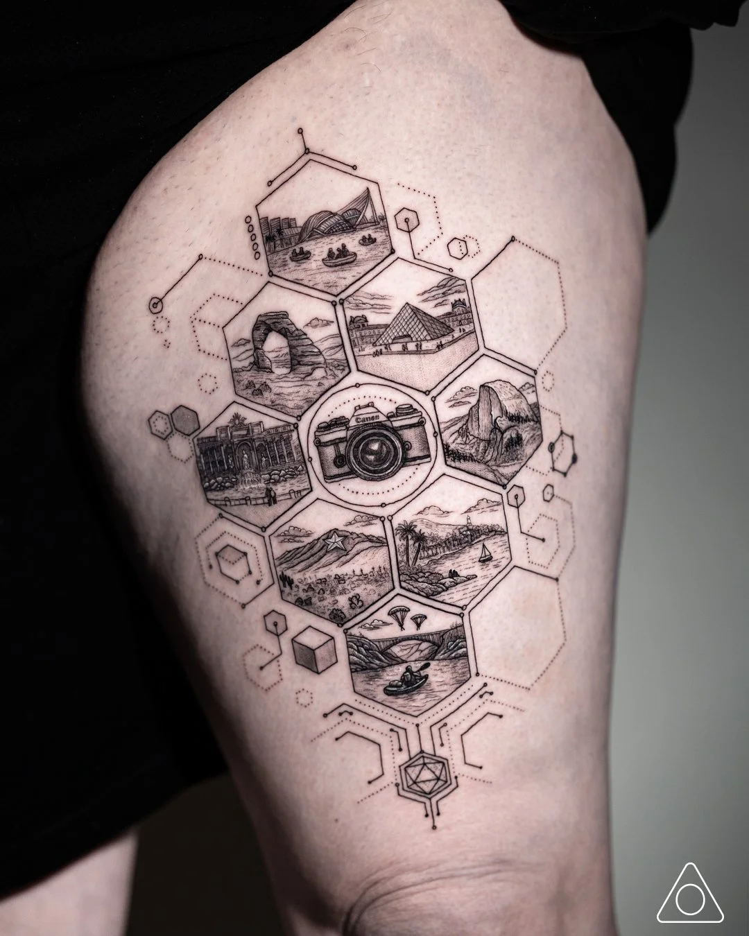Fine-line geometric travel tattoo featuring a vintage camera and hexagon landscapes, tattoo art by tattoo artist in Dallas, Texas