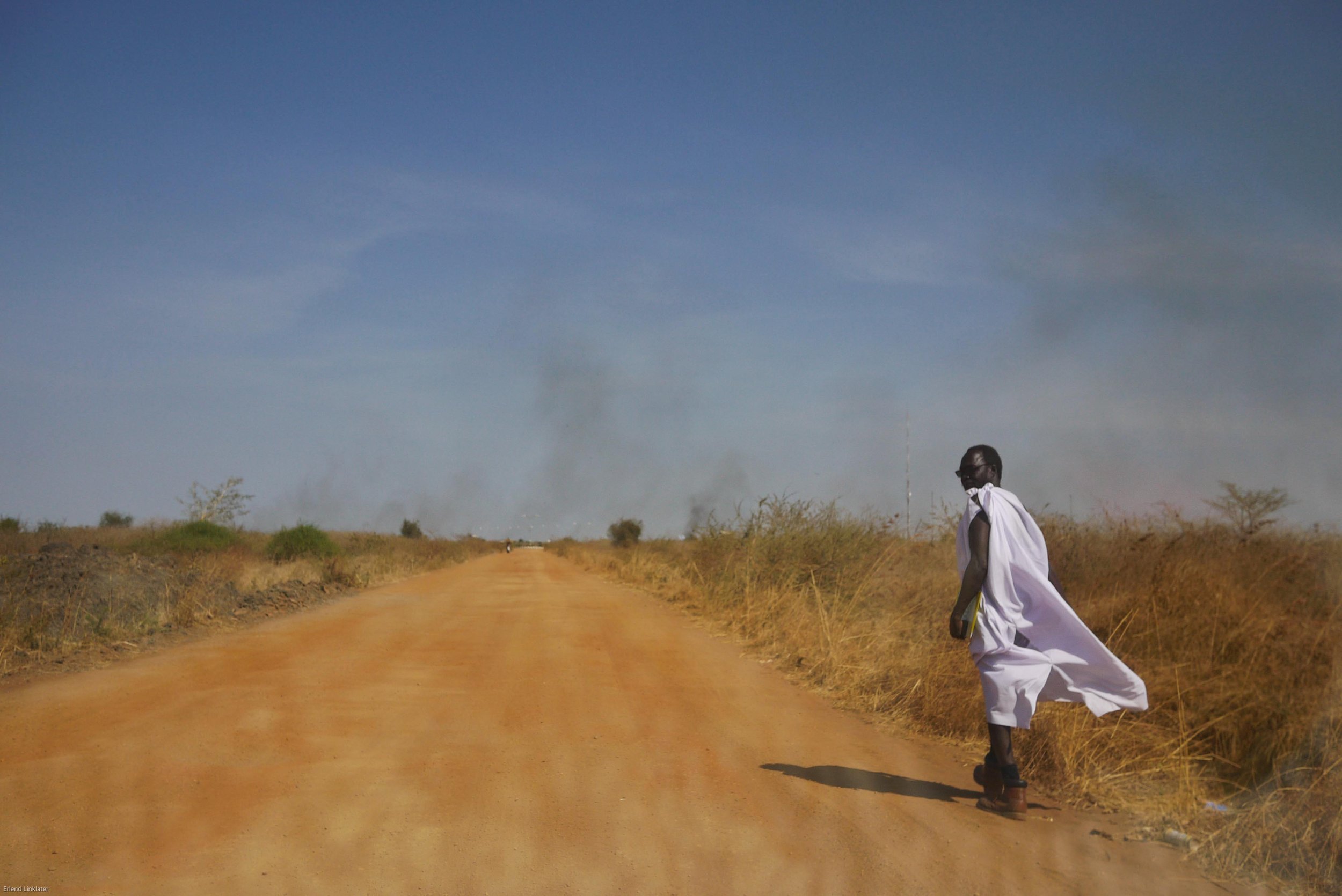 A man walks down a recently repaired road that links Malakal with the local base of the United Nations Mission in South Sudan. More than 30 years of conflict left much of the country’s infrastructure in ruin with most roads barely navigable.