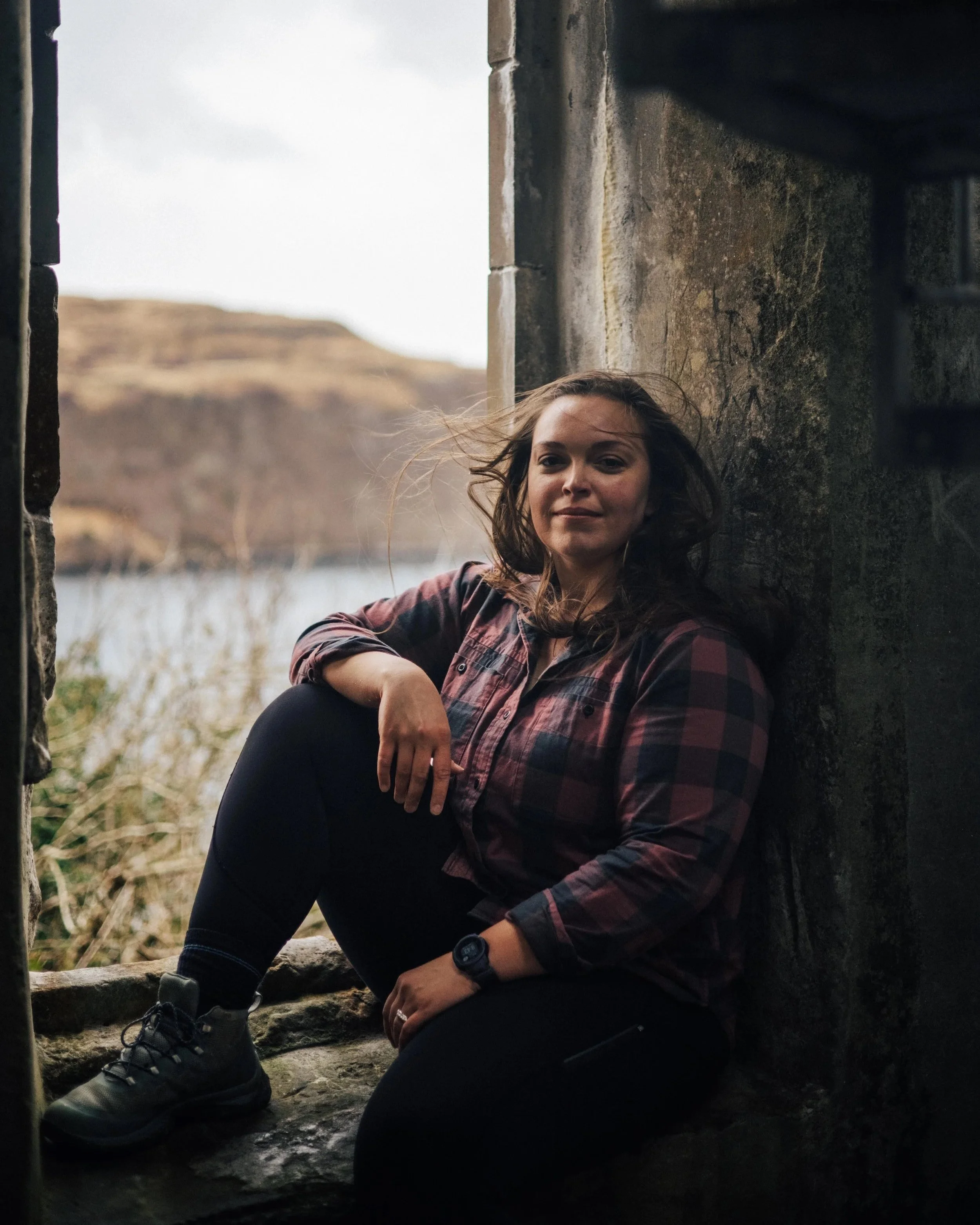 Sarah Petty sits in the window of a "folly" near Portree Harbor
