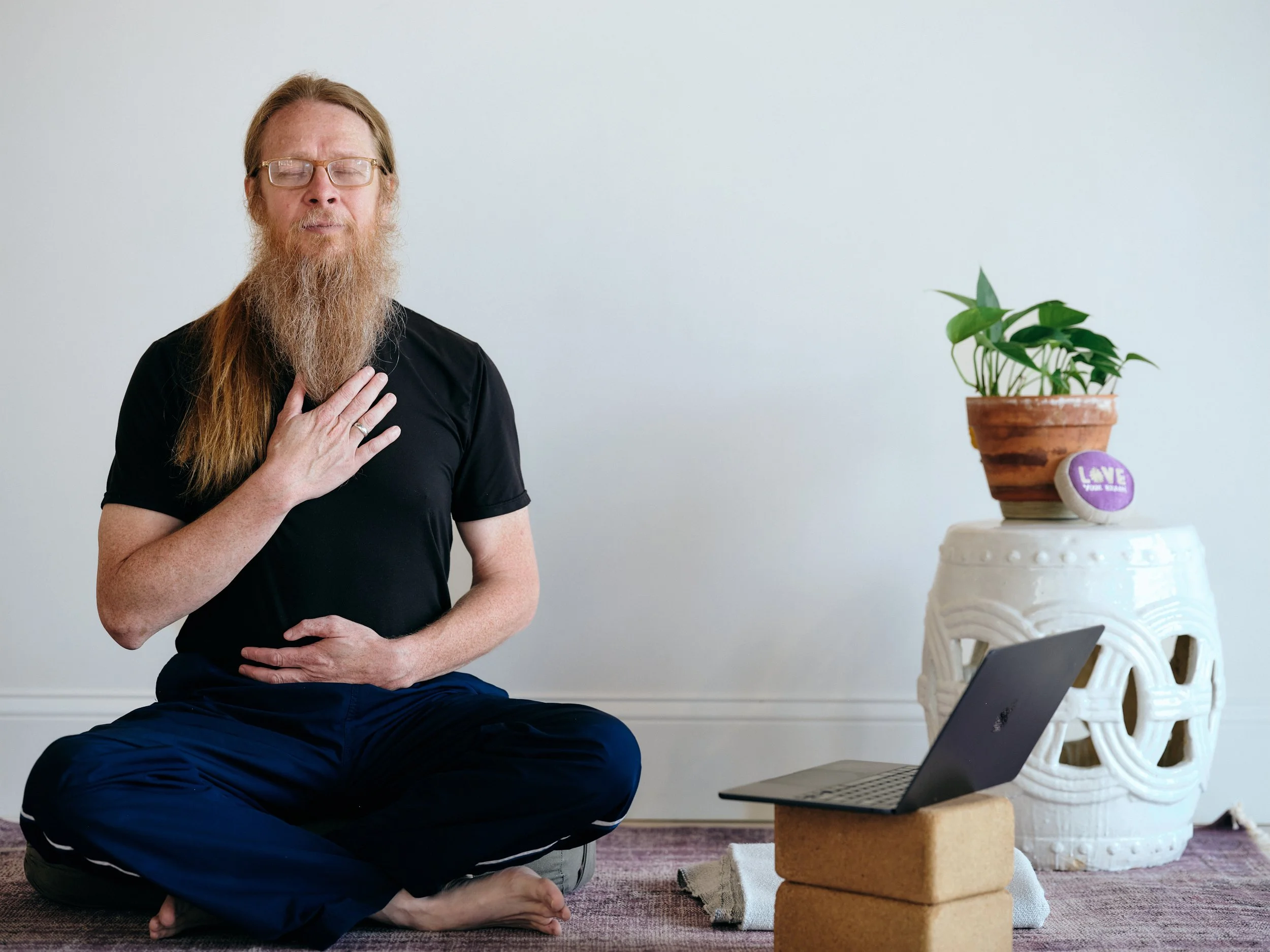 A person seated in front of a computer meditating
