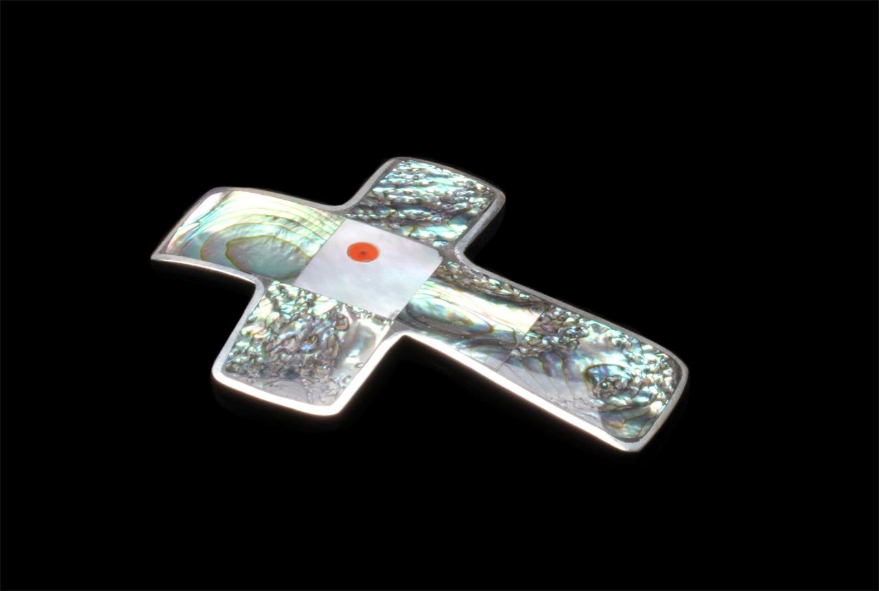   Cross Pendant/Brooch  by Mary Coriz Lovato of fabricated or tufa cast silver and inlaid with abalone shell, mother of pearl and coral. 