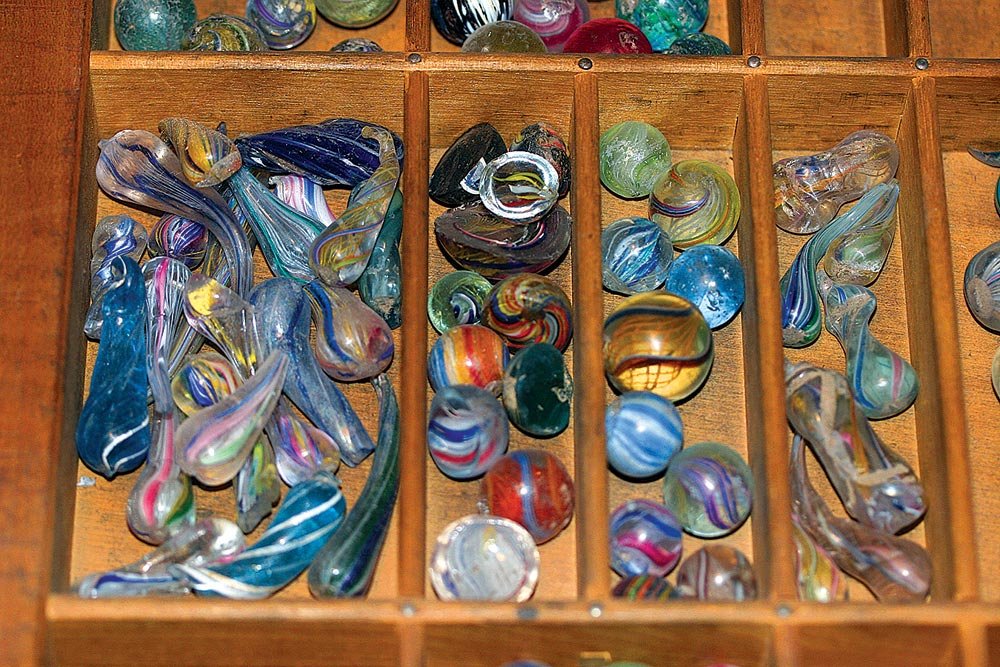  LAUSCHA MARBLES AND WASTE CANES/TUBES demonstrate the process of making marbles, some of which were drilled to become beads, while others were made into beads by hot-pinching glass tubes (Busch 2000). These were acquired from people who dug at old g