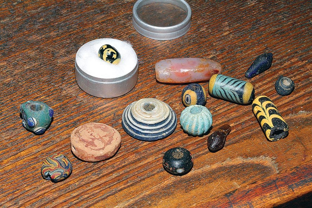  BEADS COLLECTED FROM A TURKISH BEACH by a six year-old girl, including a glass spindle whorl and a very rare Man-In-the-Moon bead. 