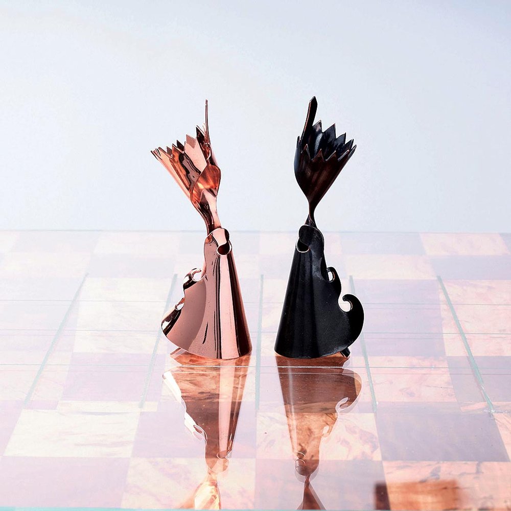  CHESS QUEENS of copper; forged, polished and antiqued, 8.9 x 3.2 centimeters, 2021.  Photograph by Dean Merrill.  