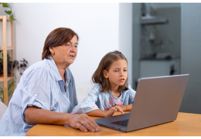 Mother and child using MoneyTime on laptop at home