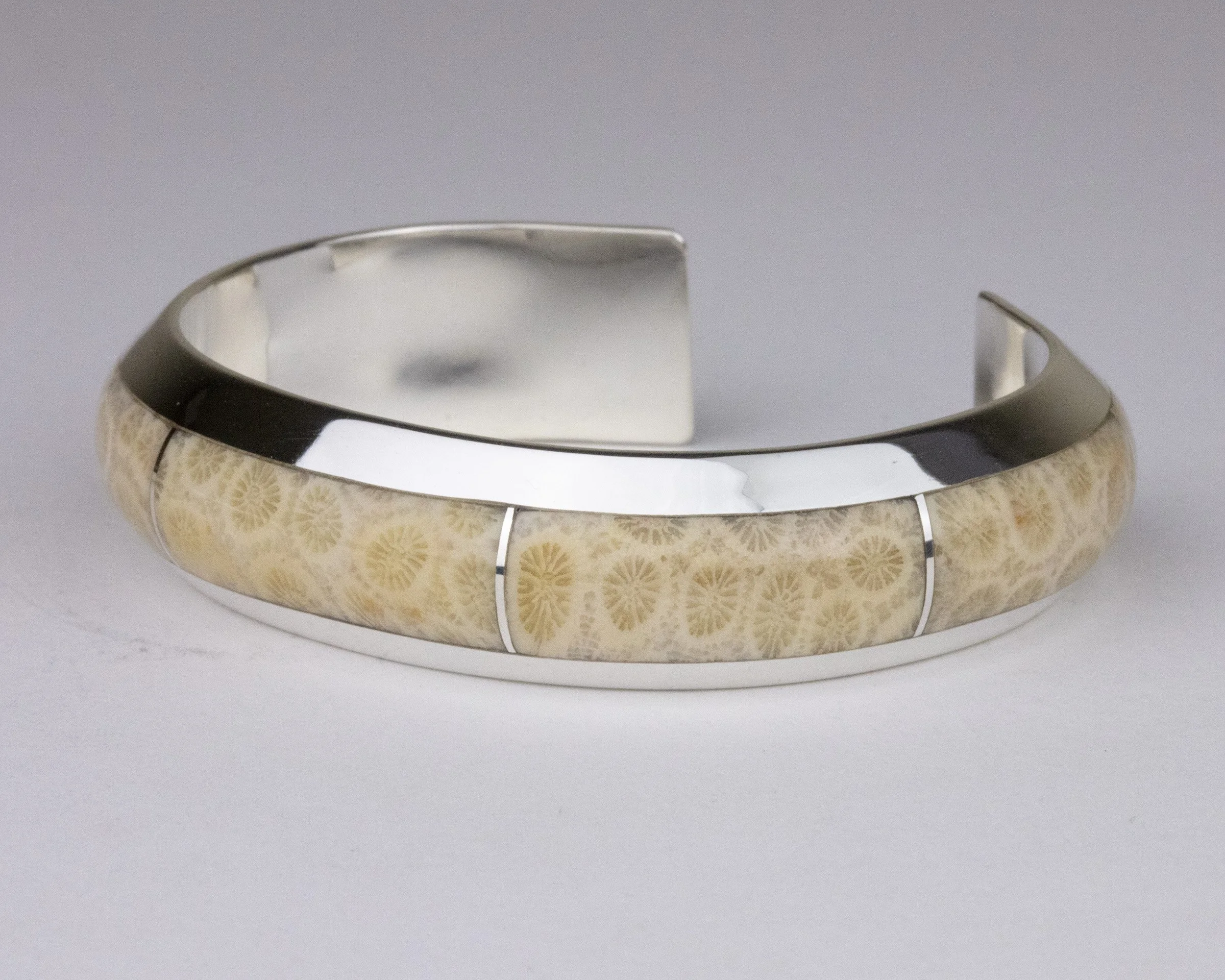 Agatized coral cuff bracelet, side view showing smoothness of a flush inlay
