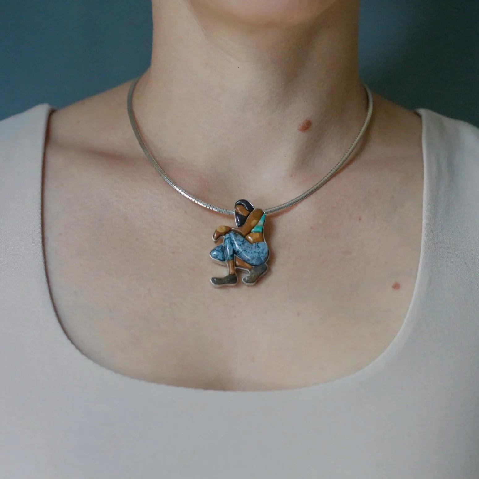 Meditation figure cobblestone inlay pendant with hand-cut petrified wood, moss agate, turquoise and other natural stones