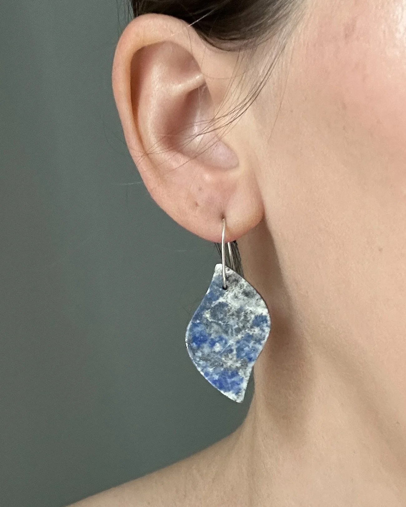 Natural lapis lazuli and sterling silver earrings; modeled on the lapidary jeweler Caitlin Albritton for scale