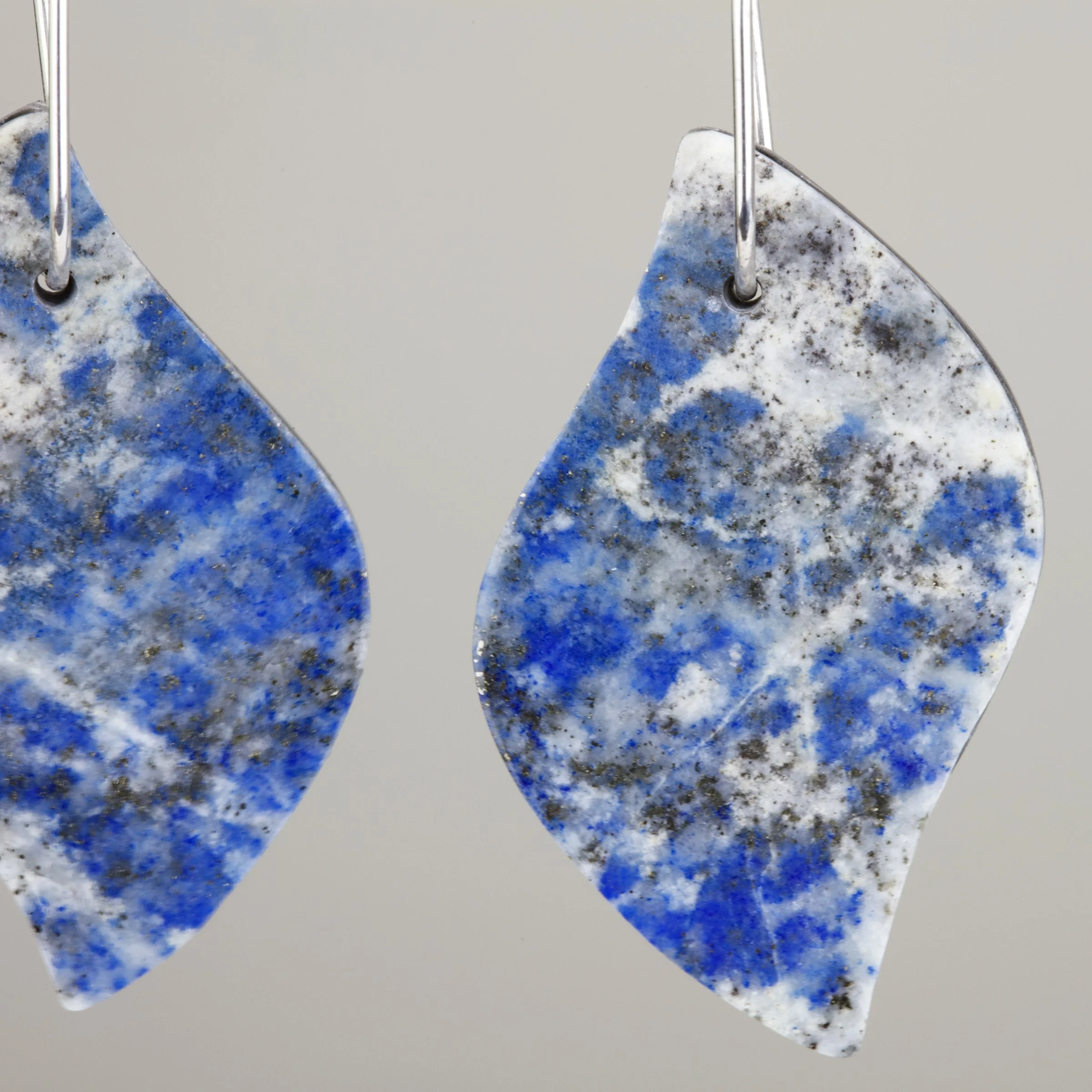 Natural stone lapis lazuli earrings with sterling silver ear wires; closeup view of denim lapis patterning in the product
