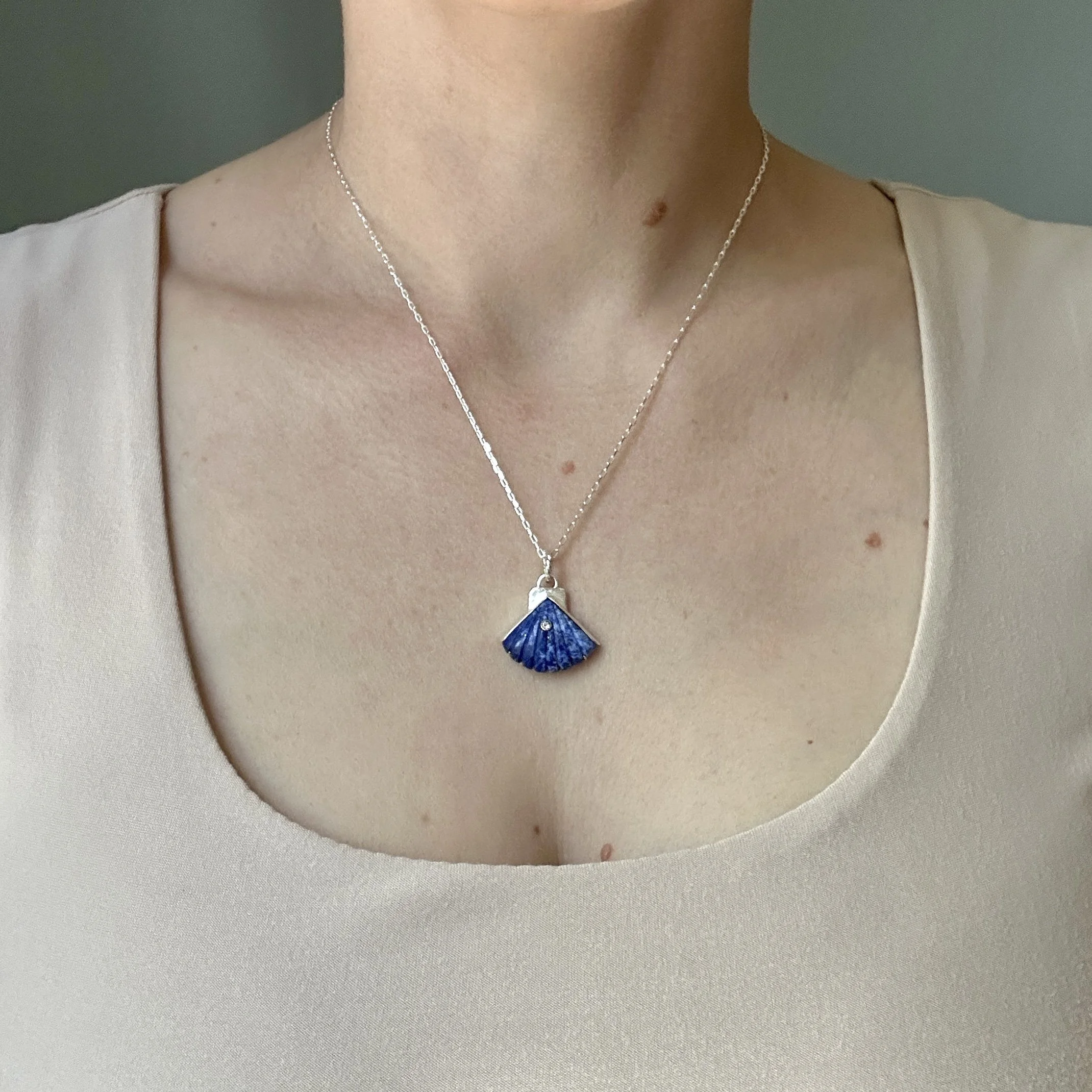 Lapis Lazuli Carved Seashell Pendant, modeled by the artist Caitlin Albritton