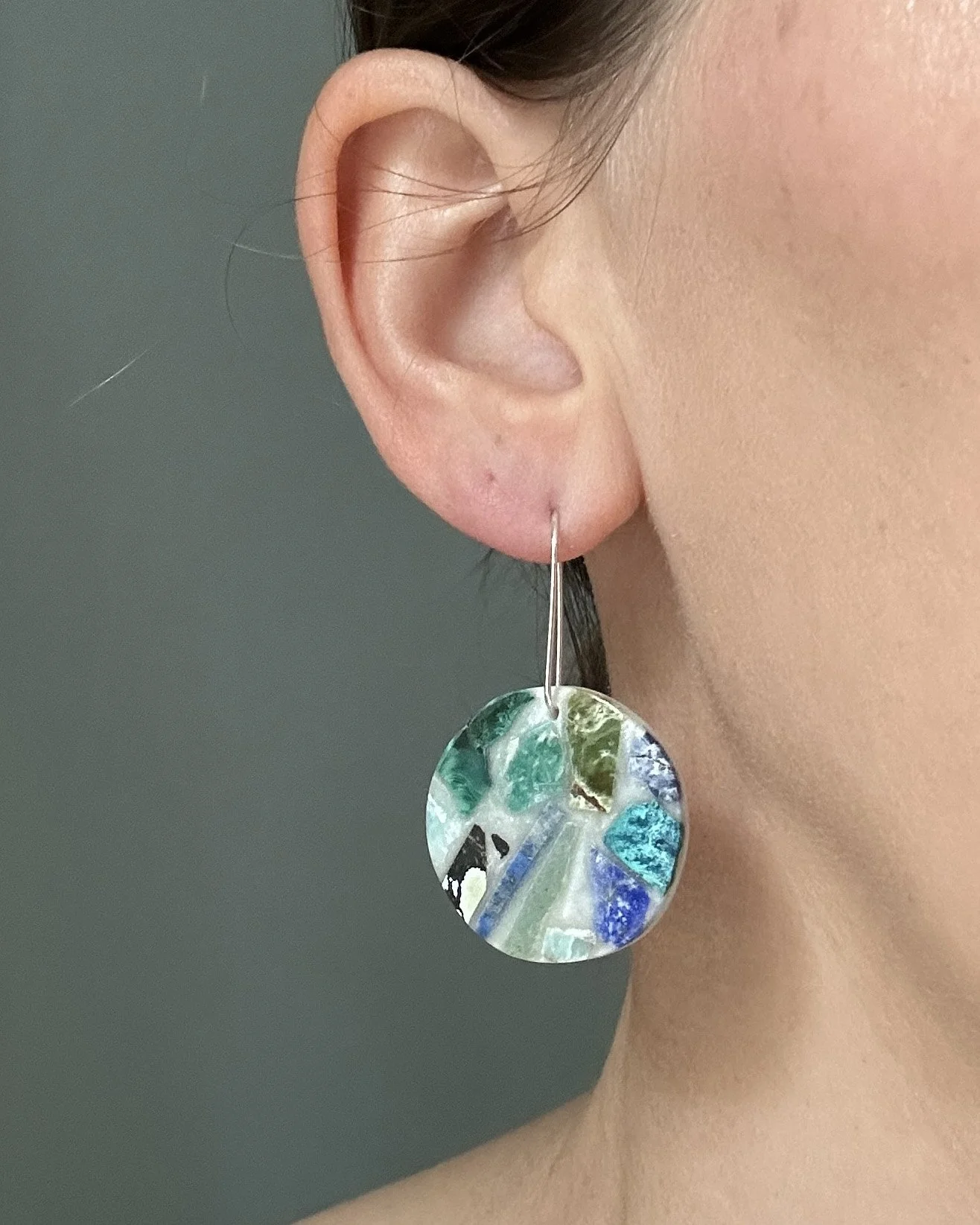 Semi-precious stone shard earrings, modeled on the jewelry artist for scale